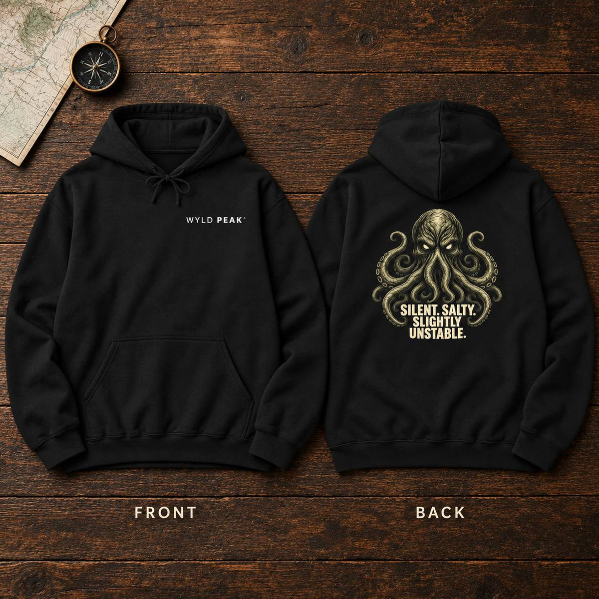 Two black hoodies shown flat on a dark wood background, labeled FRONT and BACK. The front hoodie has small white 'WYLD PEAK' text on the chest.