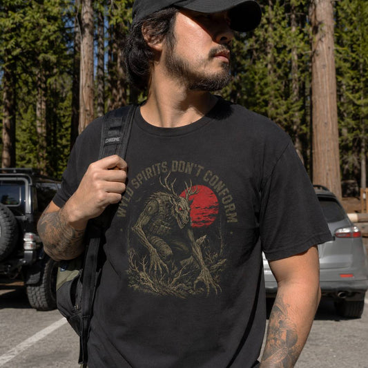 man wearing a graphic skinwalker tee at the redwoods carpark