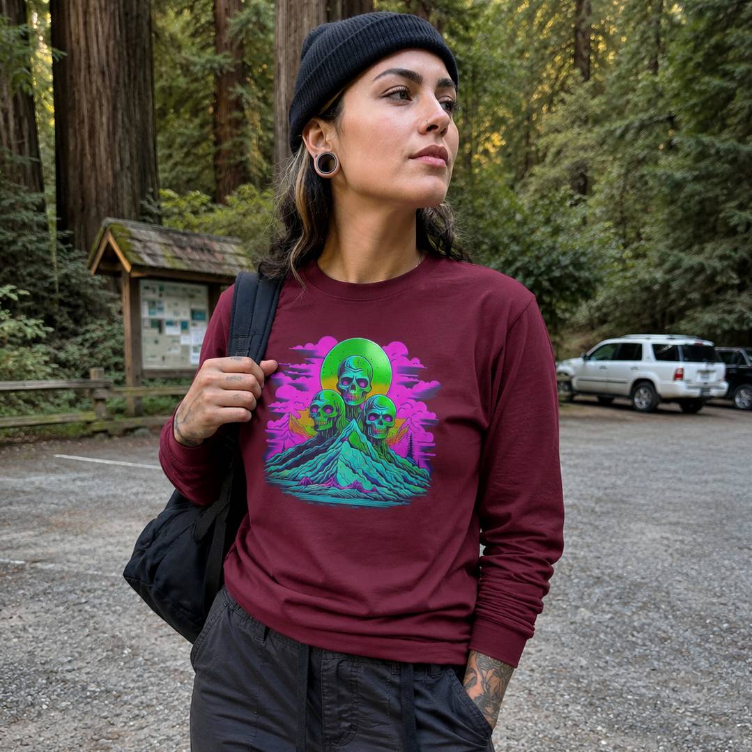 Person wearing a maroon sweatshirt with a colorful graphic design in a forest setting