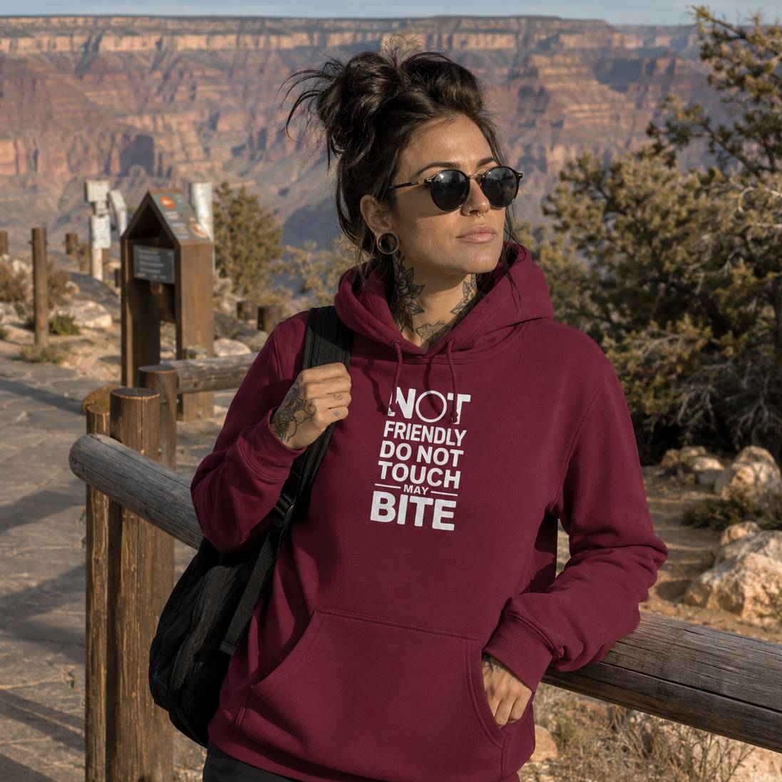 Person wearing a maroon hoodie with text at the Grand Canyon