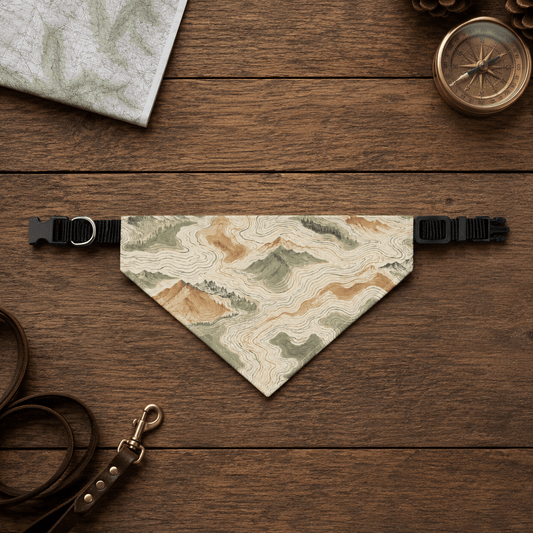 Map-themed dog bandana on a wooden surface with a compass and leash.