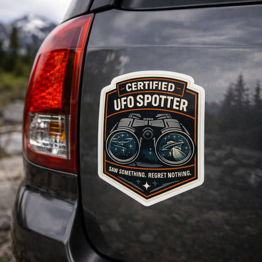 Certified UFO Spotter sticker on a car with a mountainous background