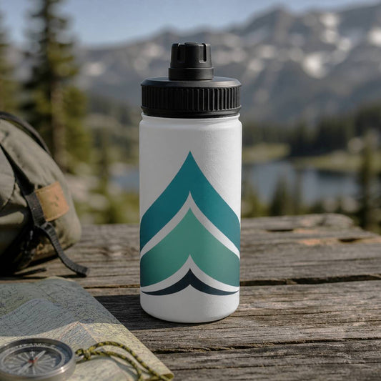 Water bottle with a geometric design on a wooden surface with a mountainous background