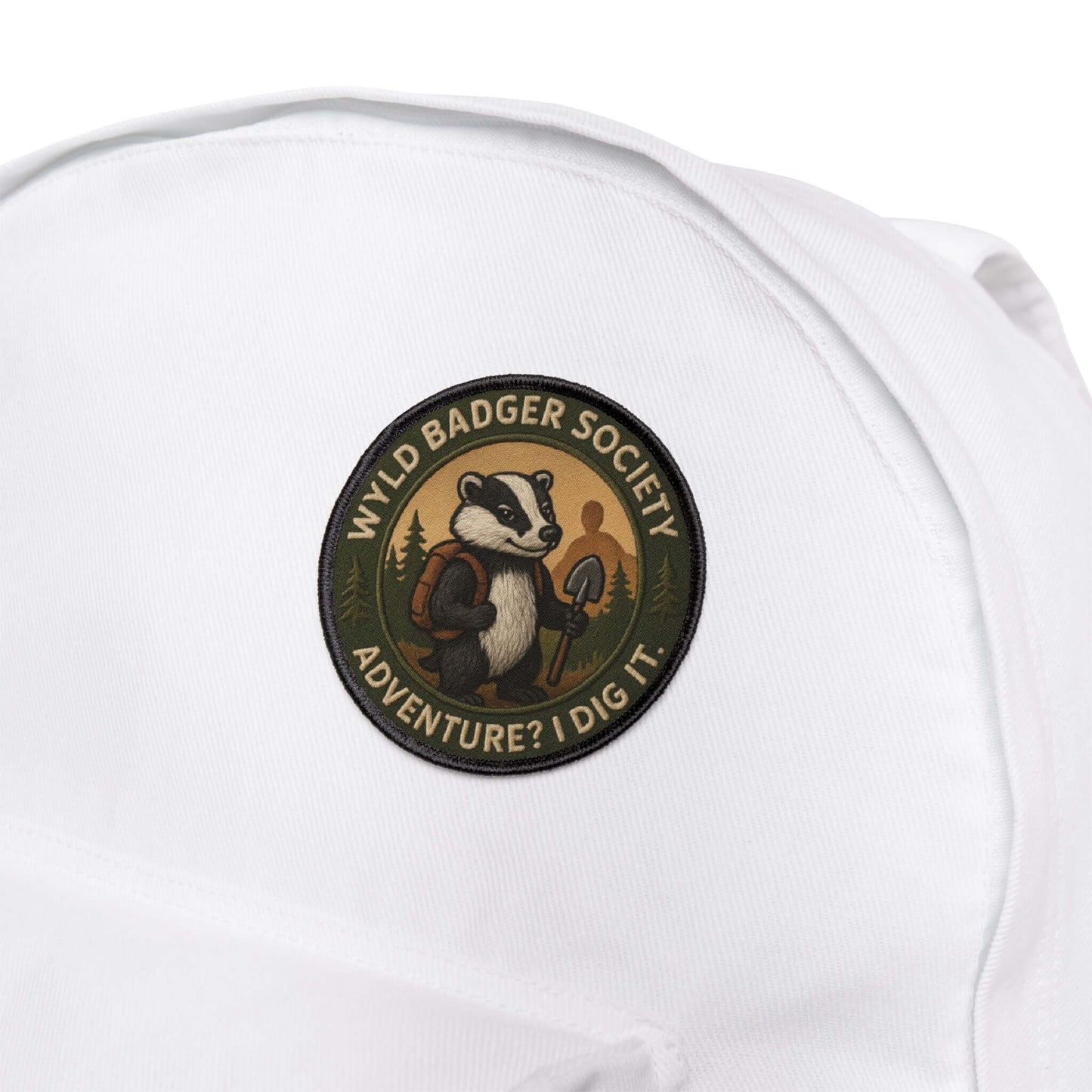 Wyld Badger Society patch attached to a white backpack, durable patch built for trails and travel