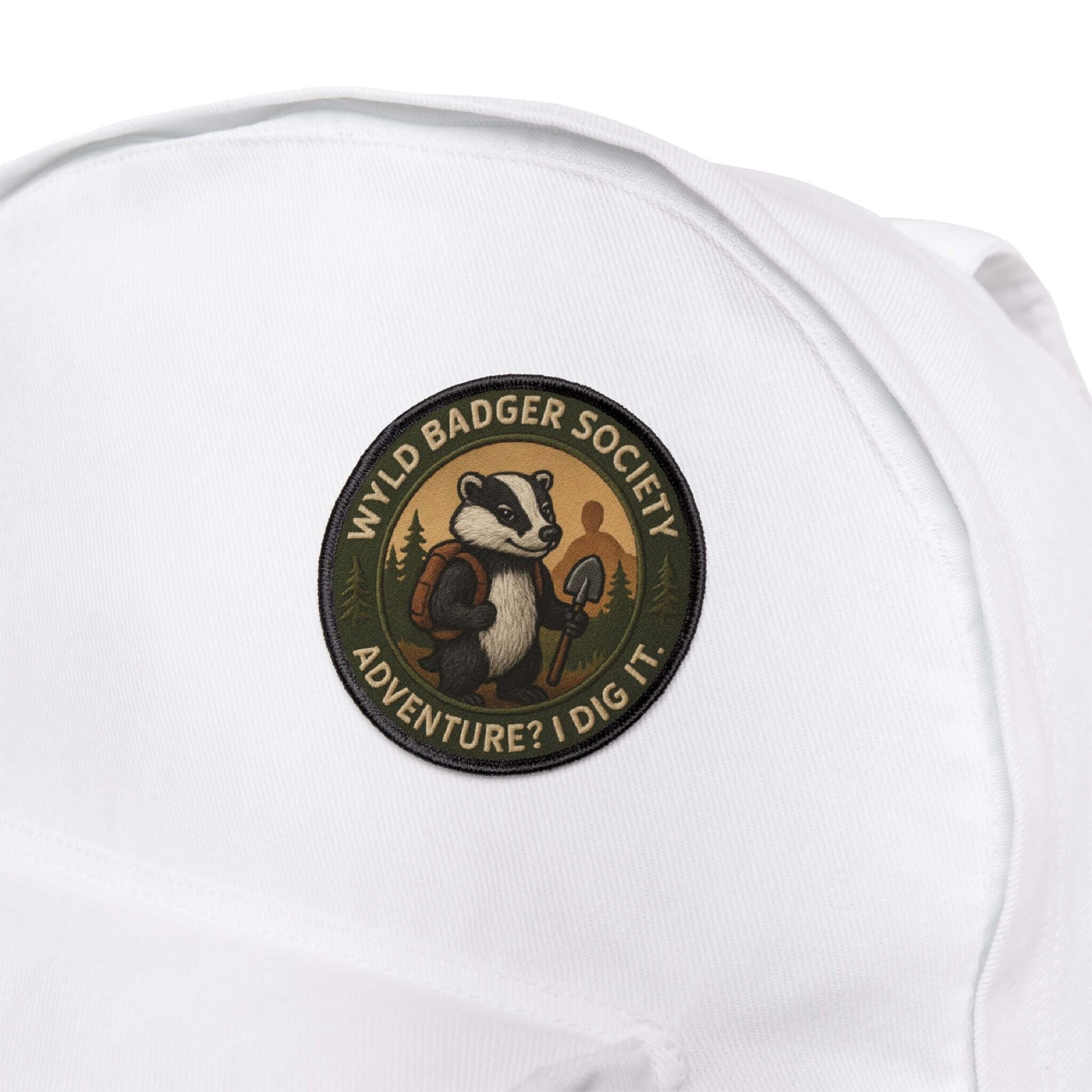 Wyld Badger Society patch attached to a white backpack, durable patch built for trails and travel