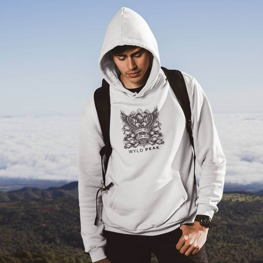Man hiking trail wearing Wyld Peak American design white hoodie.