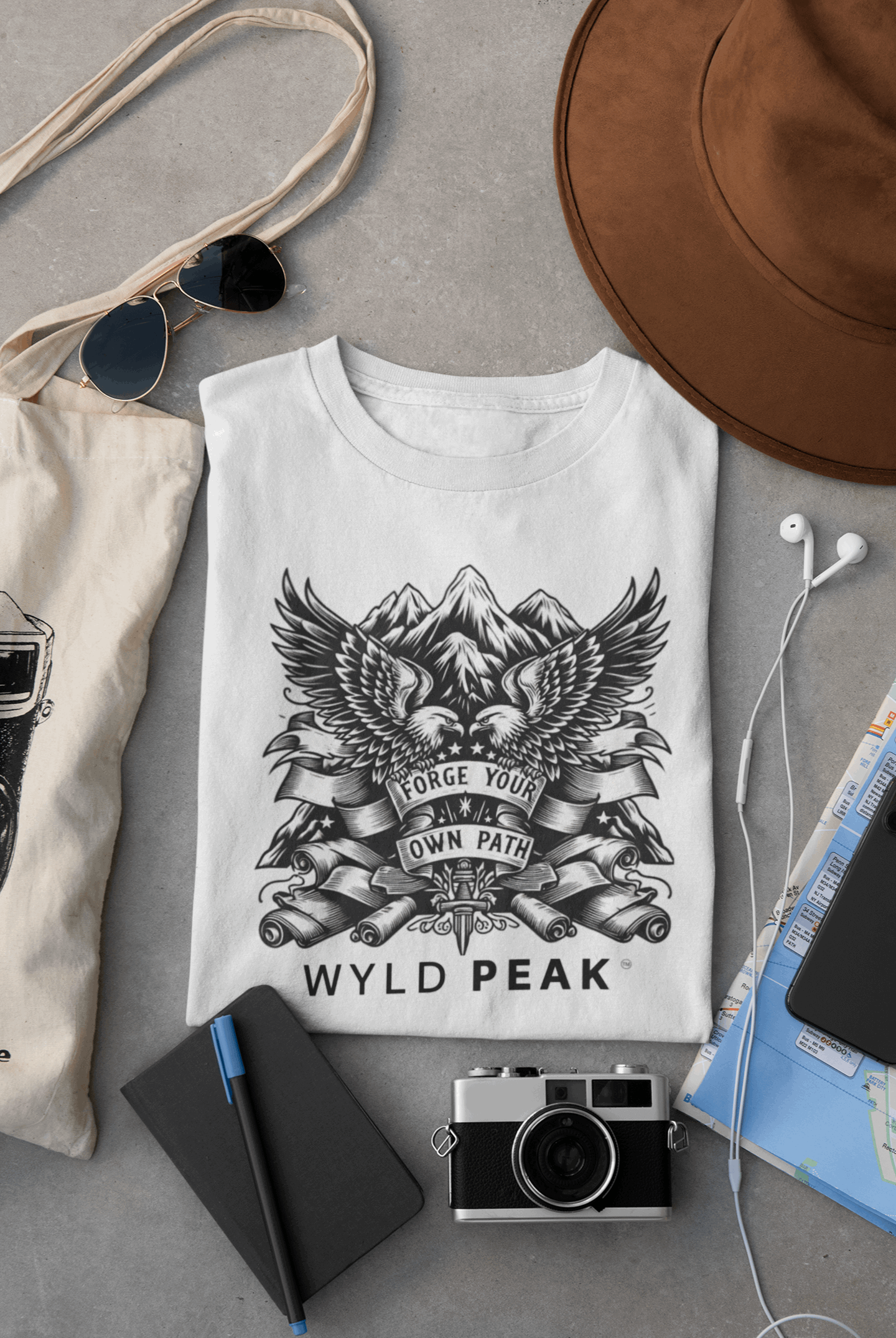 Wyld Peak American Design tee in white laid flat on desk.