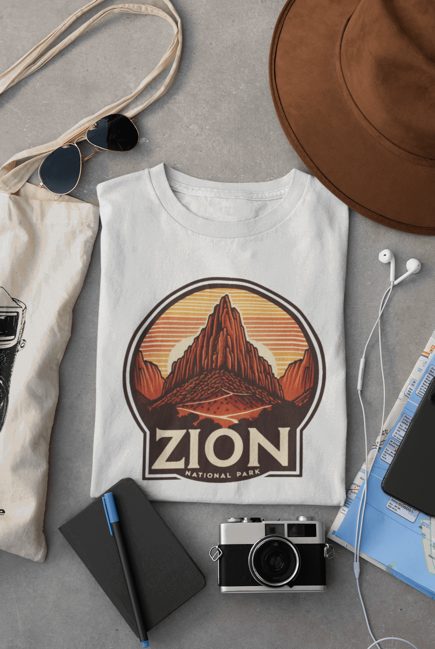 Wyld Peak Angels Landing Zion National Park organic cotton tee in white laid flat on desk.