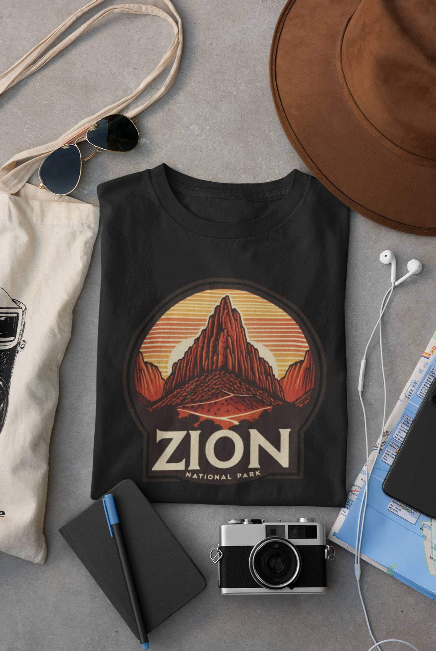 Black Angels Landing Zion National Park tee from Wyld Peak flat lay on desk.