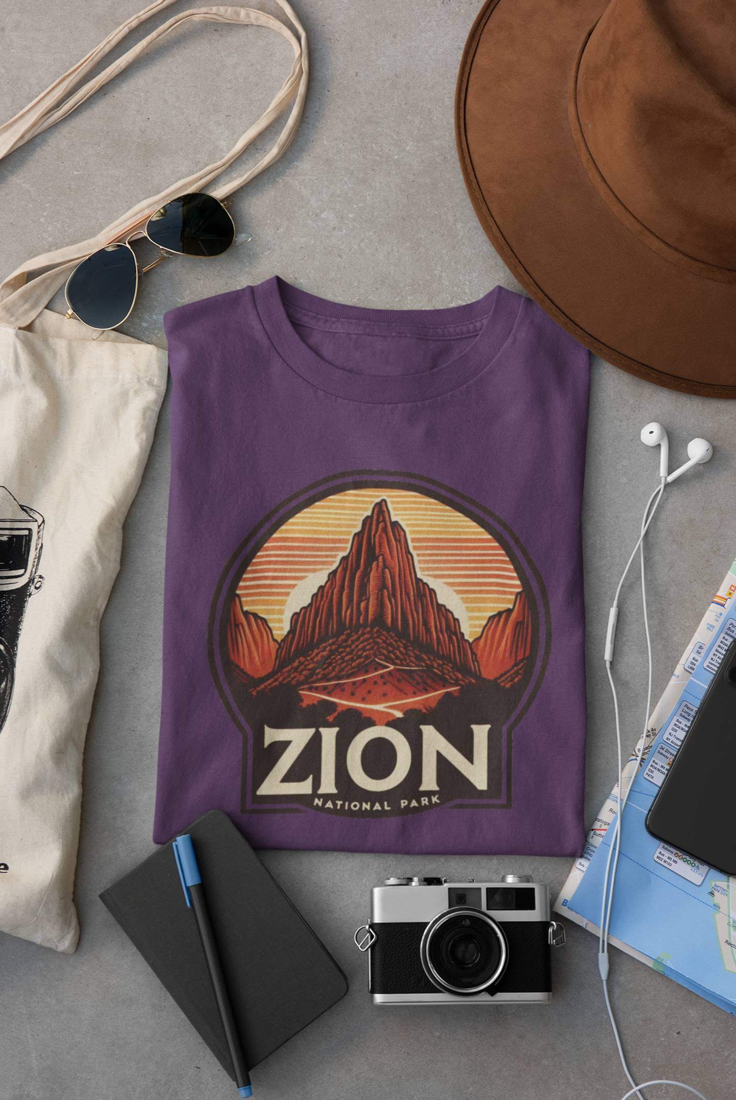 Purple Angels Landing Zion National Park tee from Wyld Peak flat lay on desk.