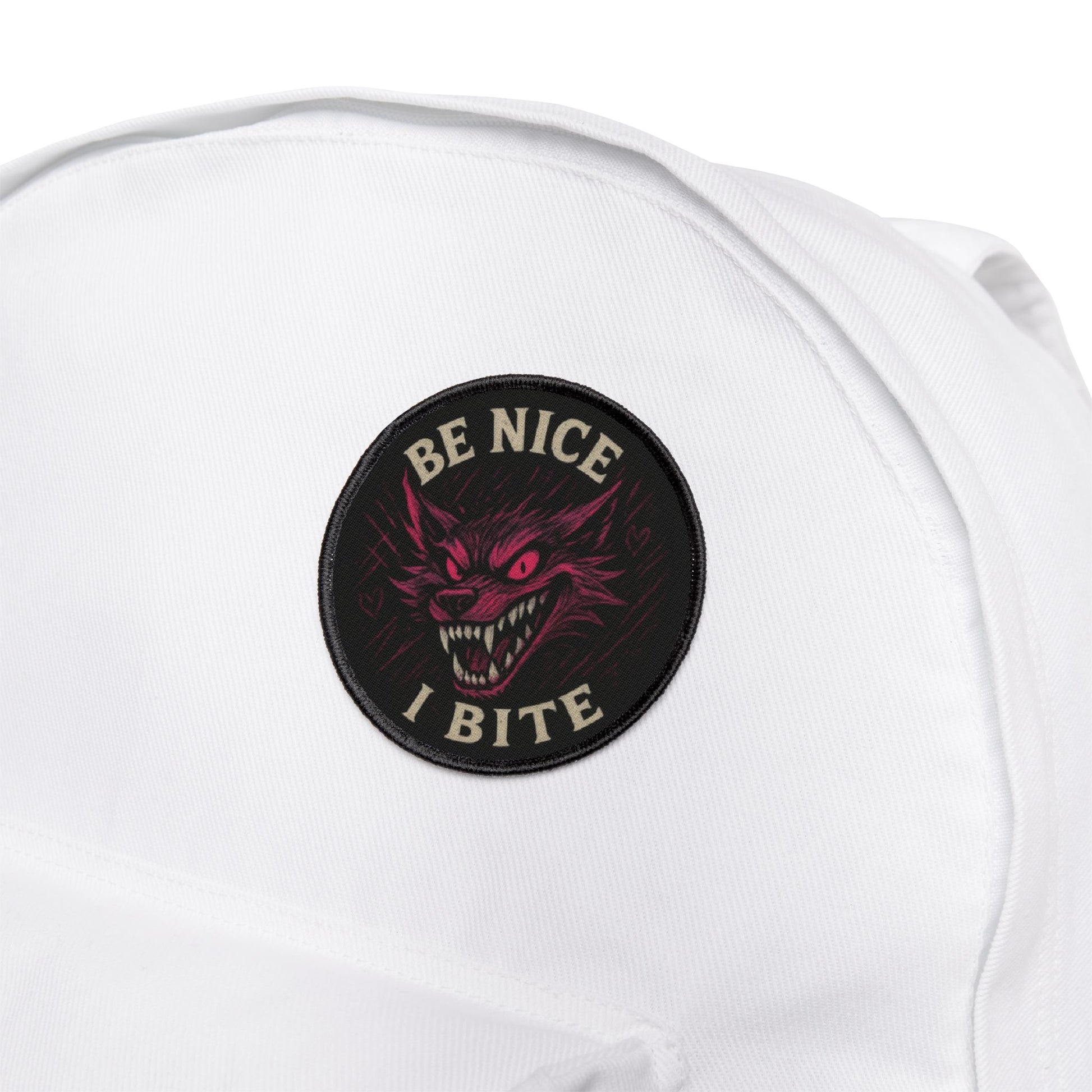 Be Nice I Bite wolf patch attached to a white backpack, expressive design built for daily carry and travel