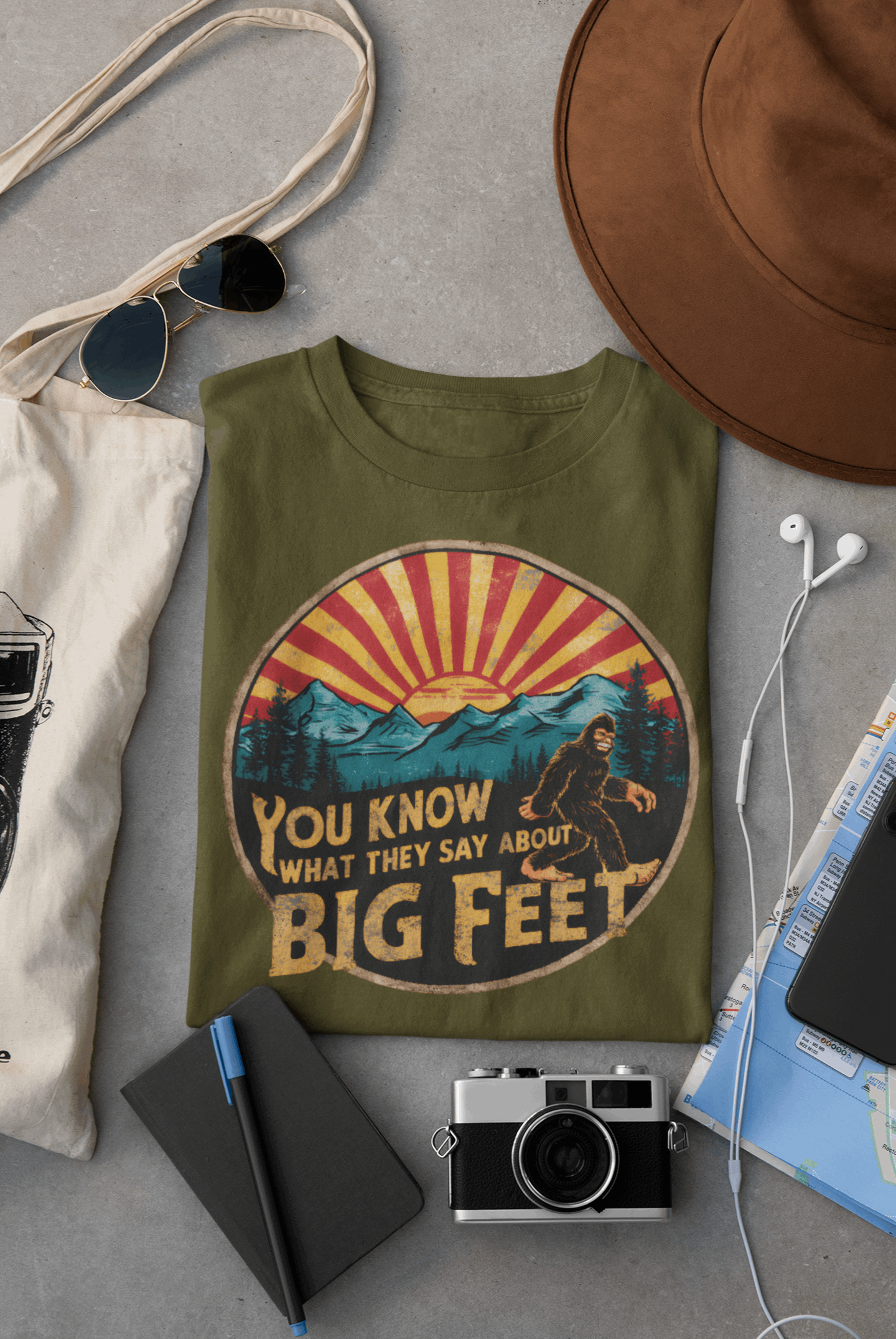 Army green Wyld Peak Bigfoot women's organic t-shirt flat lay on desk