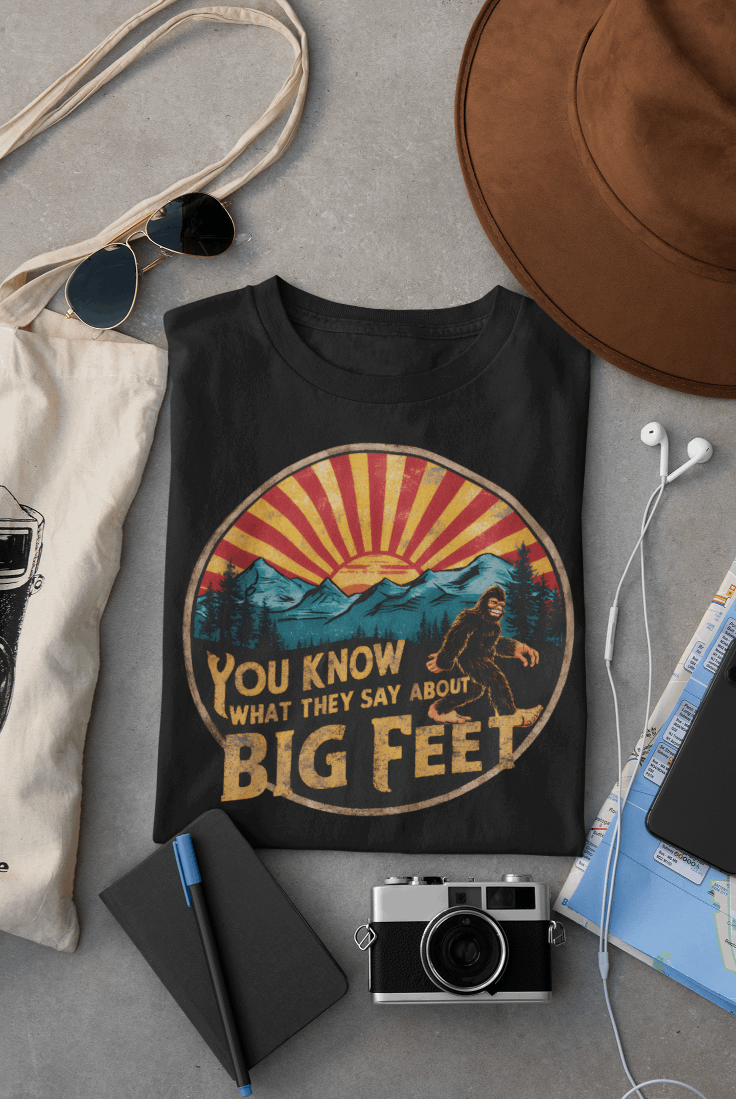 Black Wyld Peak Bigfoot women's organic t-shirt laid flat on desk background