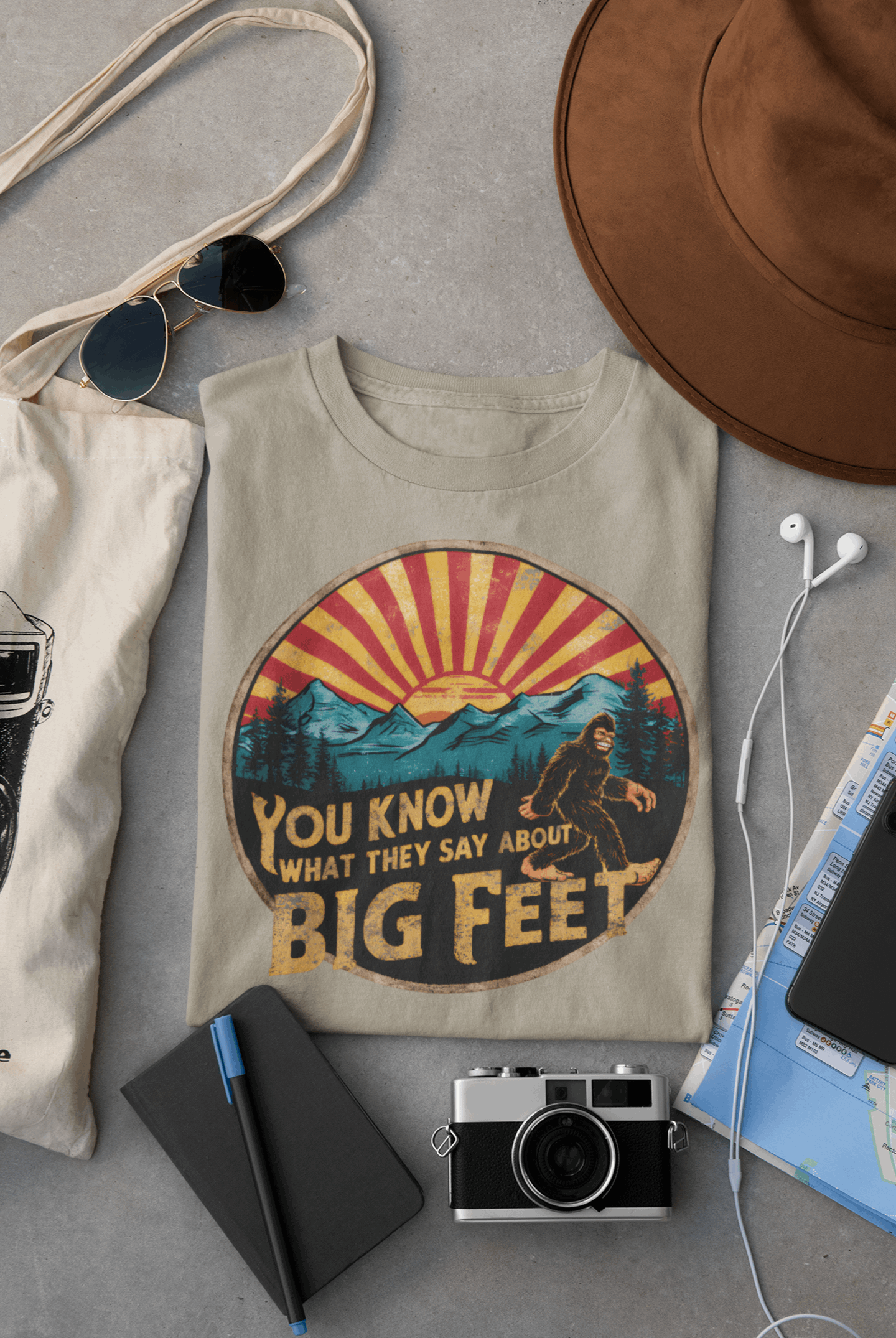 Wyld Peak Bigfoot women's organic tee in desert tan color, laid flat on desk