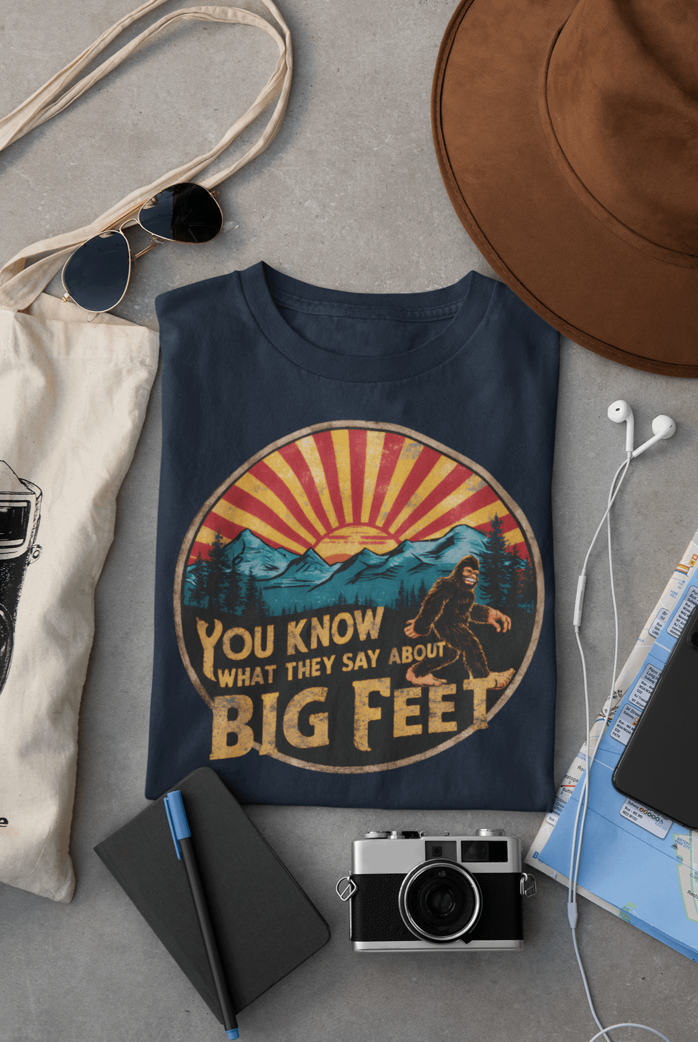 Navy blue Wyld Peak Bigfoot organic cotton women's tee laid flat on desk