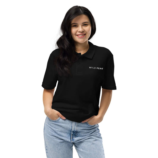 Woman wearing a black Wyld Peak polo shirt.