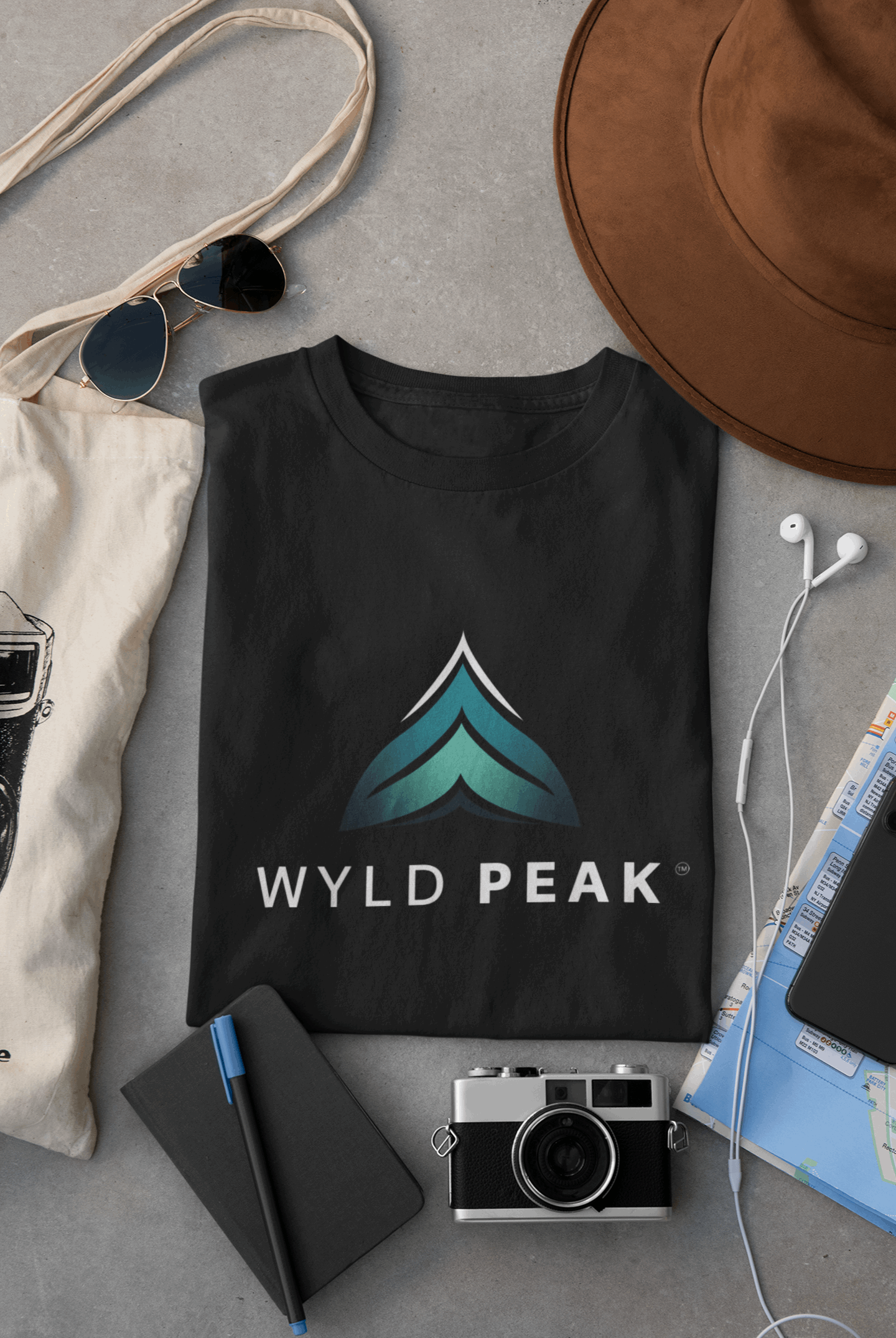 Black Wyld Peak branded men's organic cotton t-shirt laid flat on desk