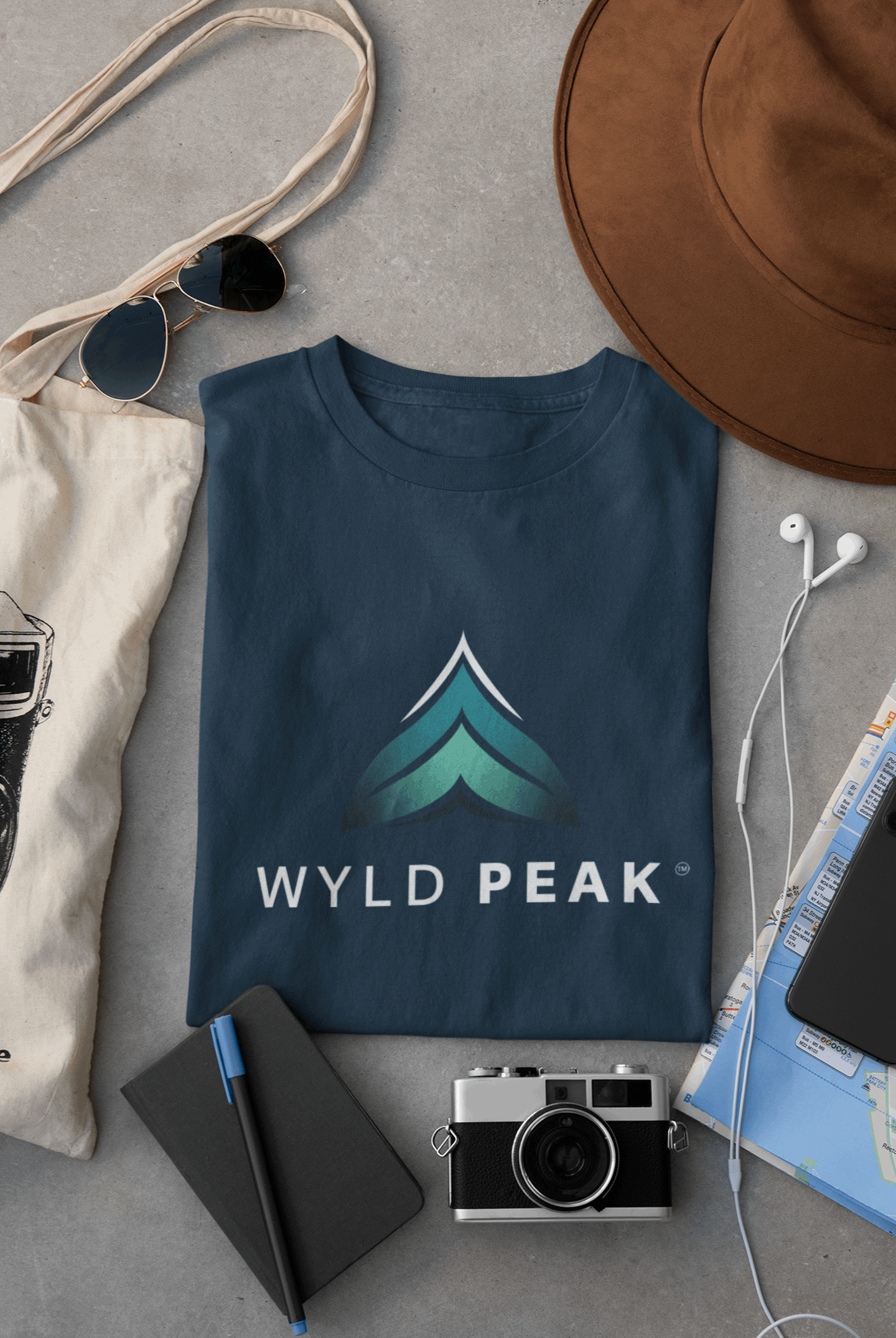 Navy blue Wyld Peak branded men's organic cotton t-shirt laid flat on desk