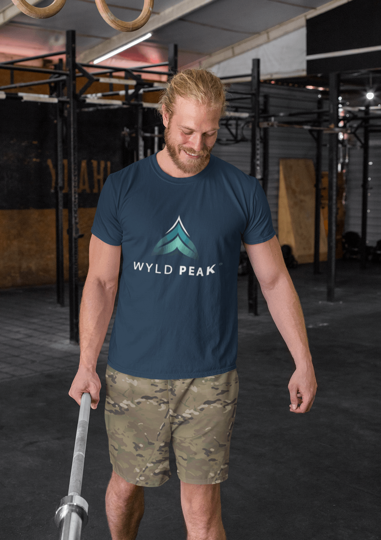 Man wearing navy Wyld Peak branded men's organic cotton t-shirt at gym