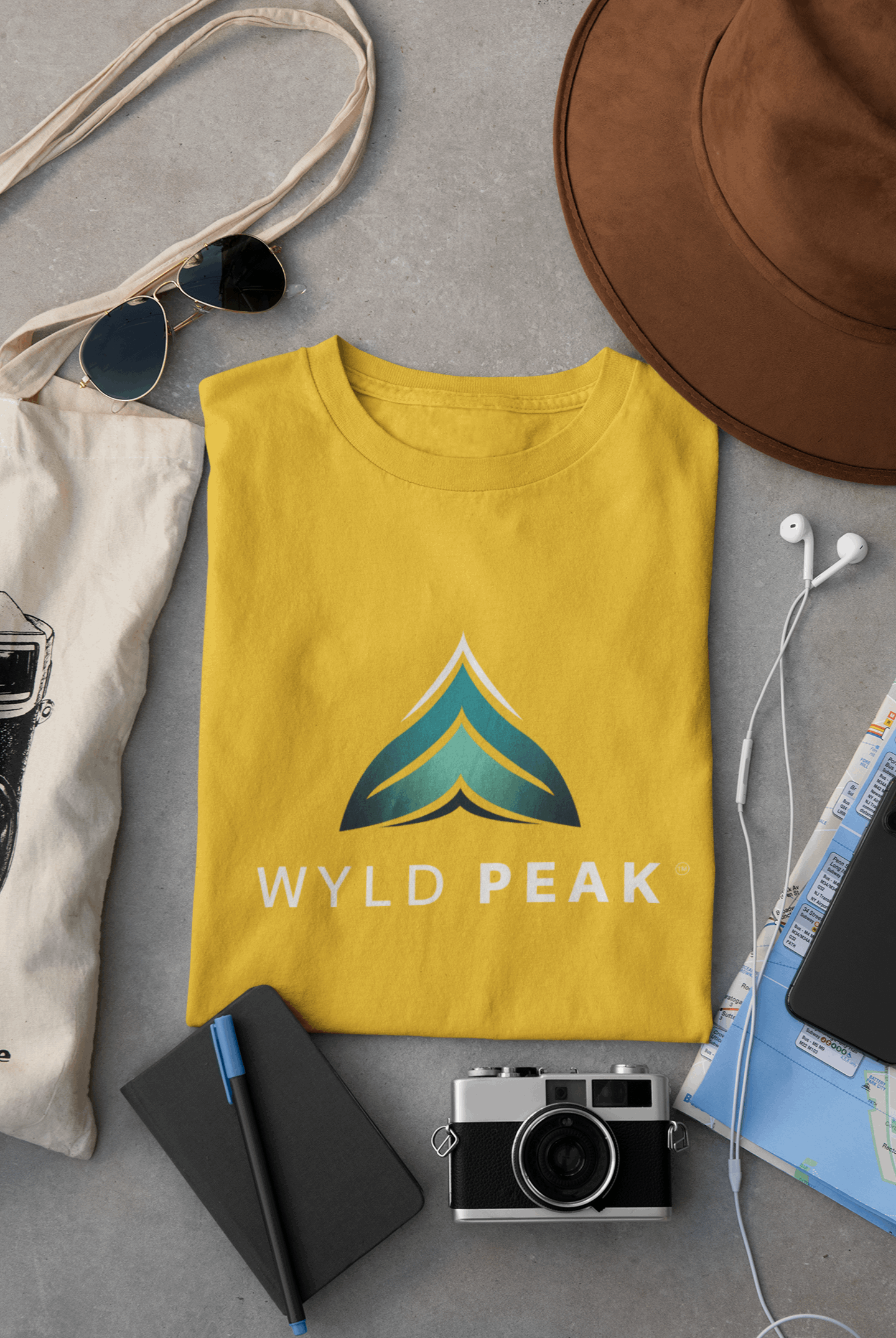 Wyld Peak branded men's organic cotton t-shirt in yellow, laid flat for product view
