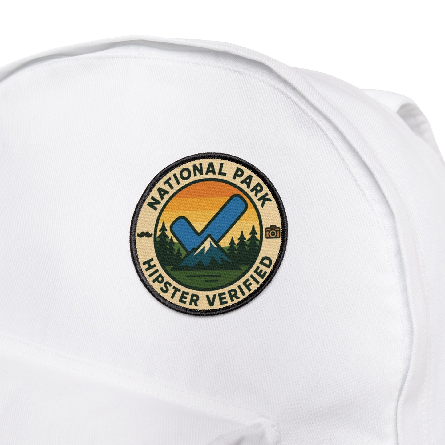 Funny National Park Patch Hipster Verified from Wyld Peak on white backpack with white background.