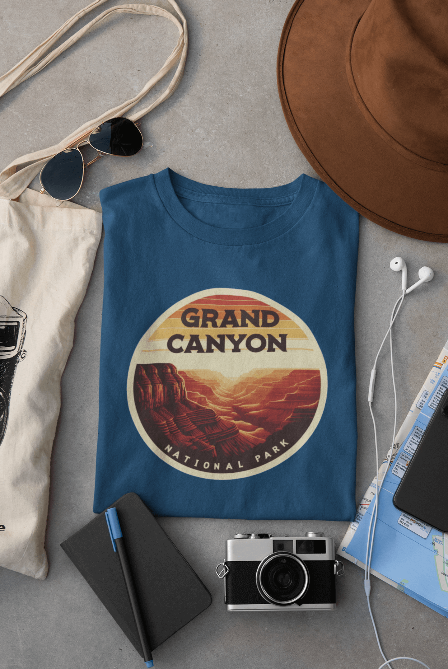 Indigo blue Grand Canyon South Rim tee from Wyld Peak flat lay on desk.