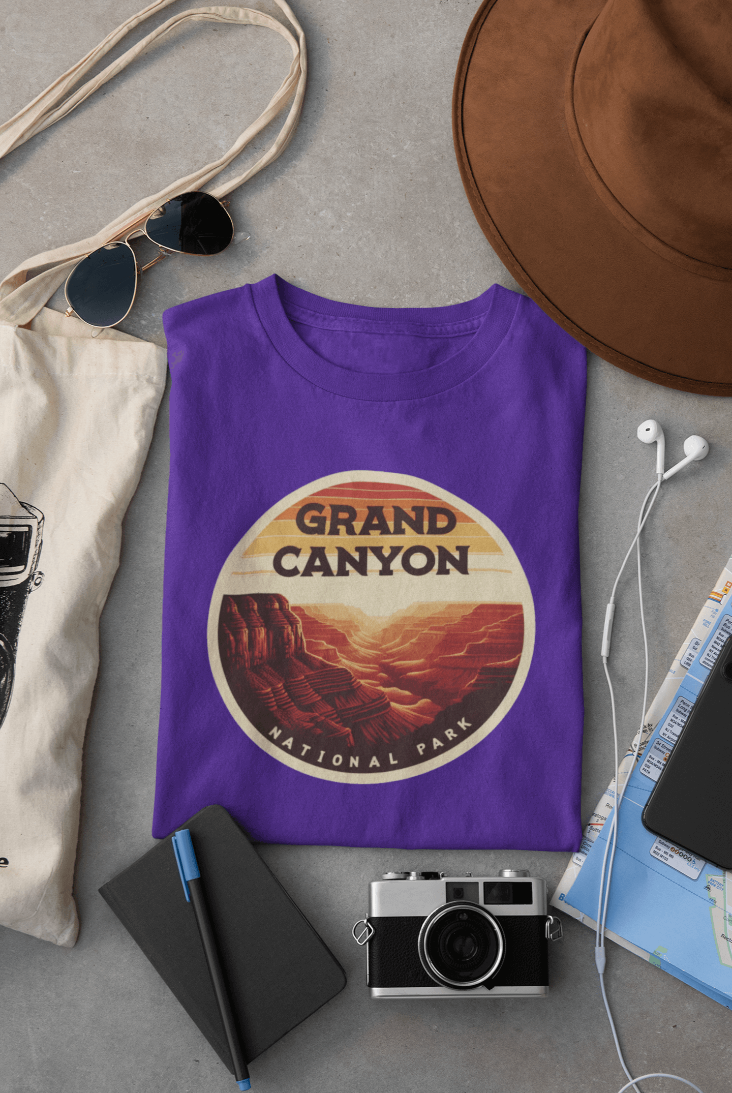 Purple Grand Canyon South Rim tee from Wyld Peak flat lay on desk.