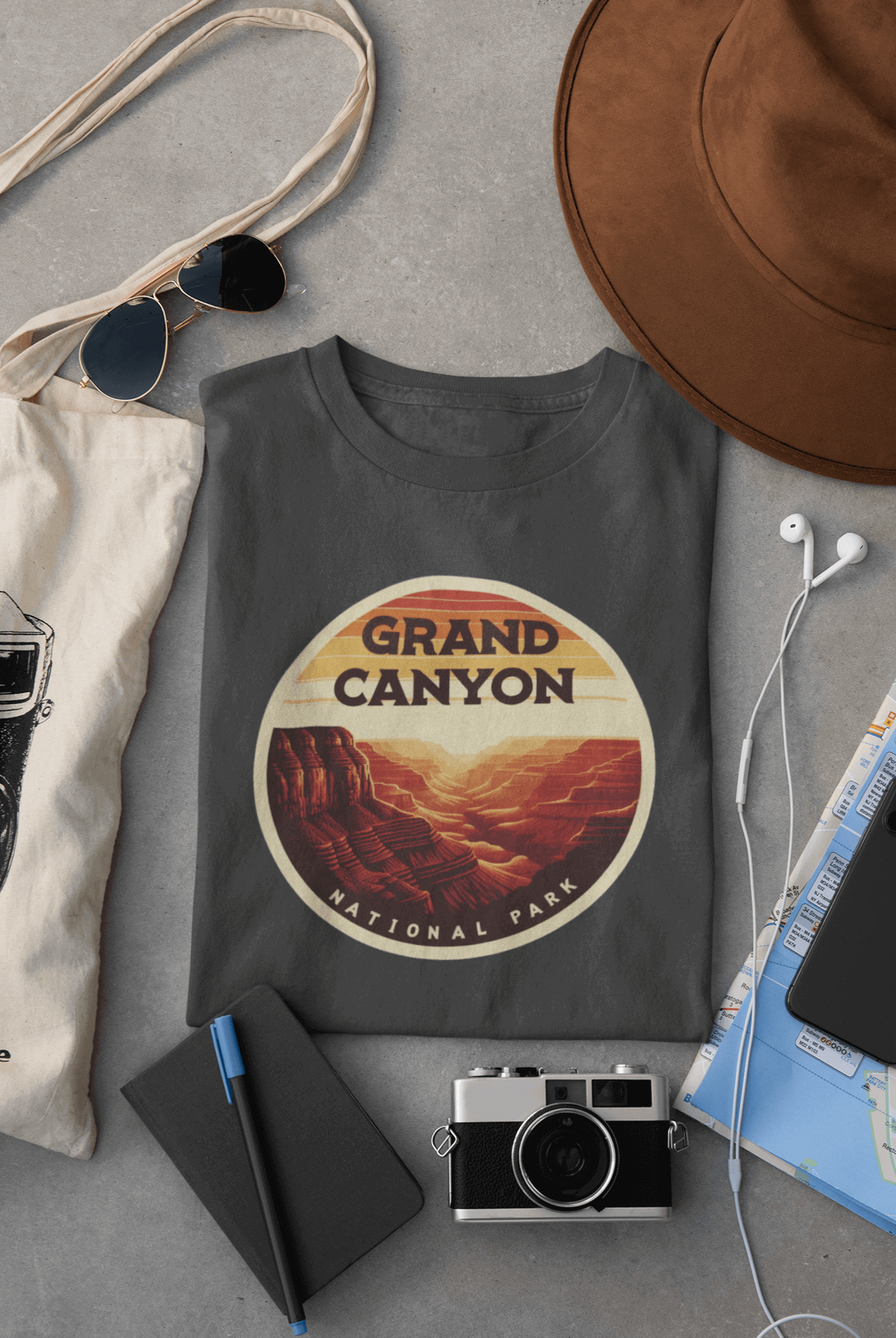 Wyld Peak Grand Canyon National Park organic cotton tee in charcoal laid flat on desk.