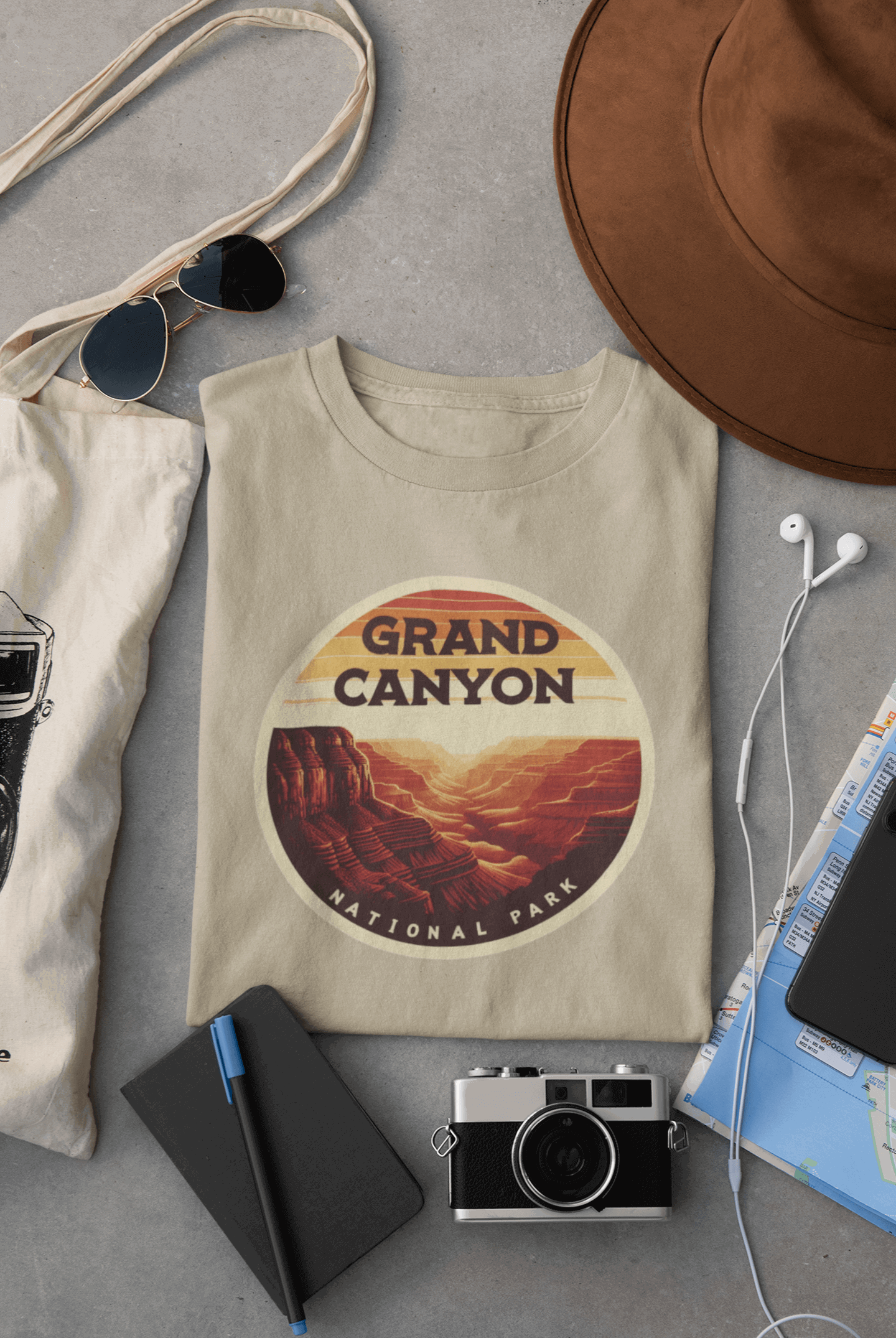 Wyld Peak Grand Canyon National Park organic cotton tee in desert tan laid flat on desk.