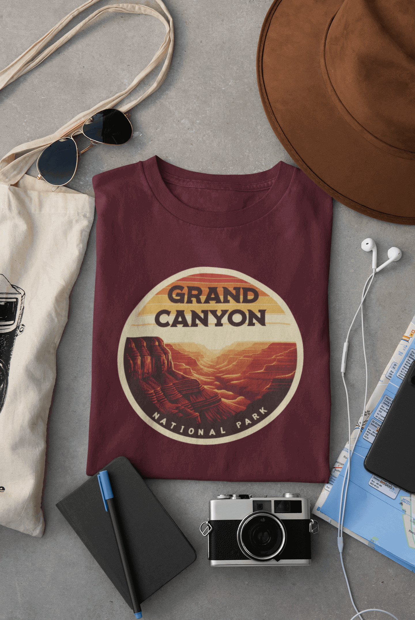 Maroon Wyld Peak Grand Canyon National Park organic cotton tee laid flat on desk.