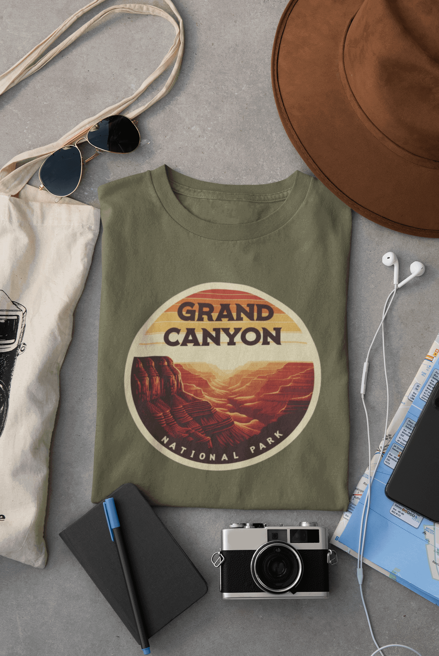 Wyld Peak Grand Canyon National Park organic cotton tee in military green laid flat on desk.