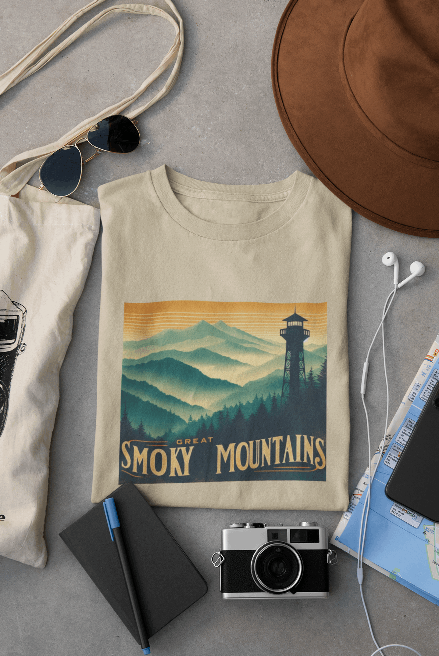 Wyld Peak Great Smoky Mountains National Park organic cotton tee in desert tan laid flat on desk.