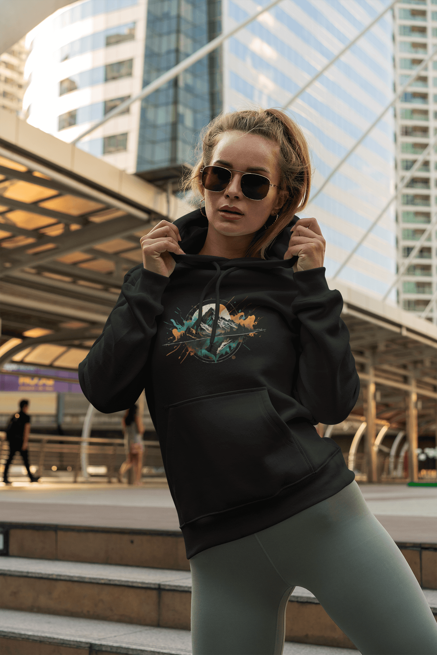 Woman in lifestyle setting wearing Wyld Peak Peak Design hoodie.