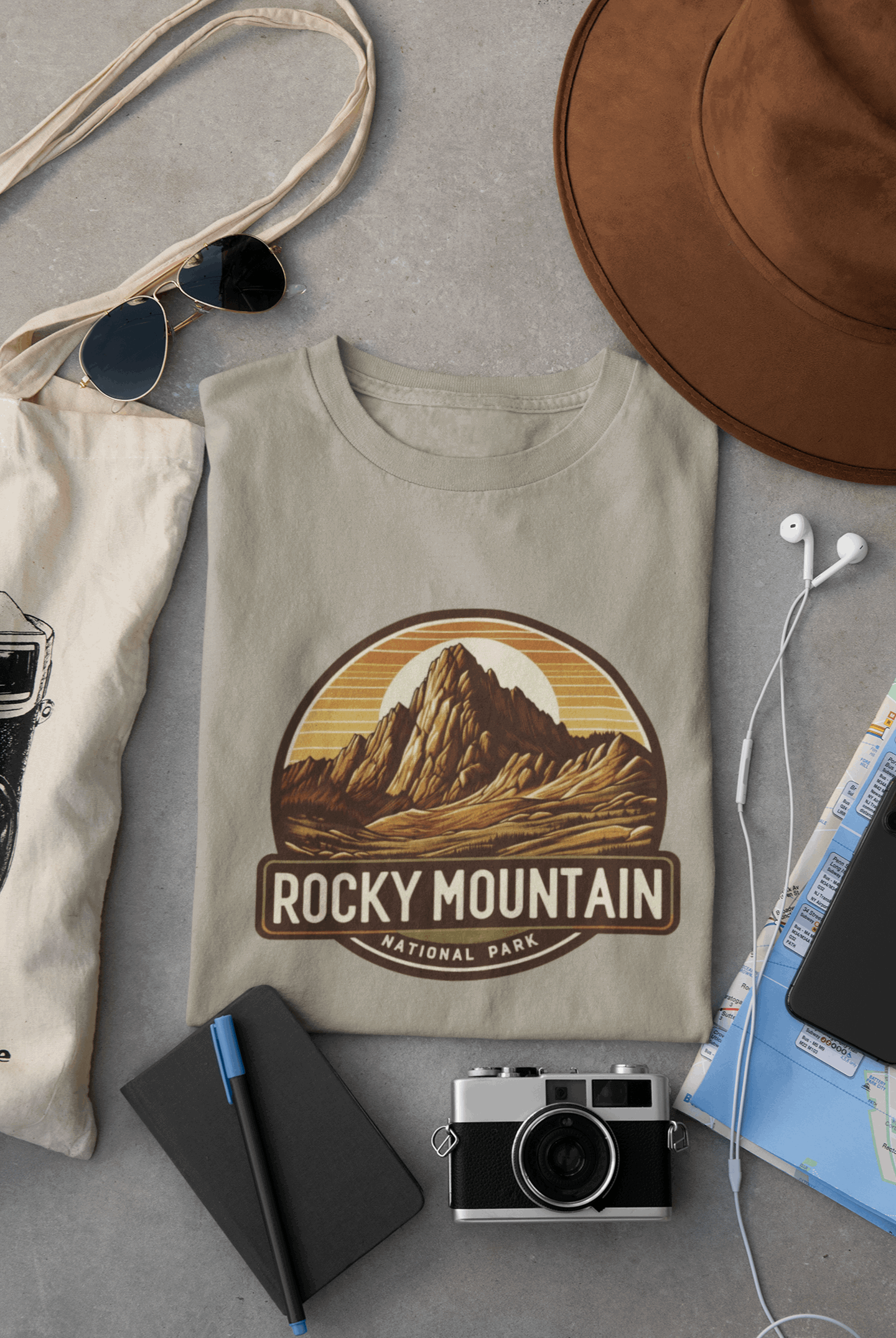 Wyld Peak Longs Peak Rocky Mountain National Park organic cotton tee in desert tan laid flat on desk.