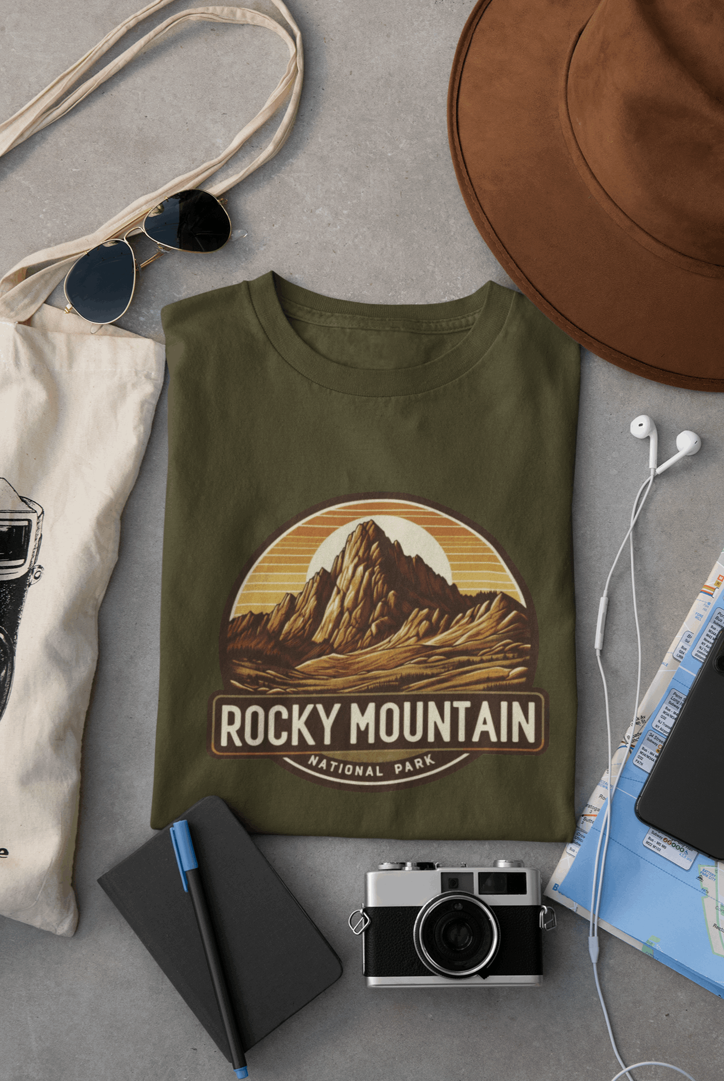 Wyld Peak Longs Peak Rocky Mountain National Park organic cotton tee in military green laid flat on desk.