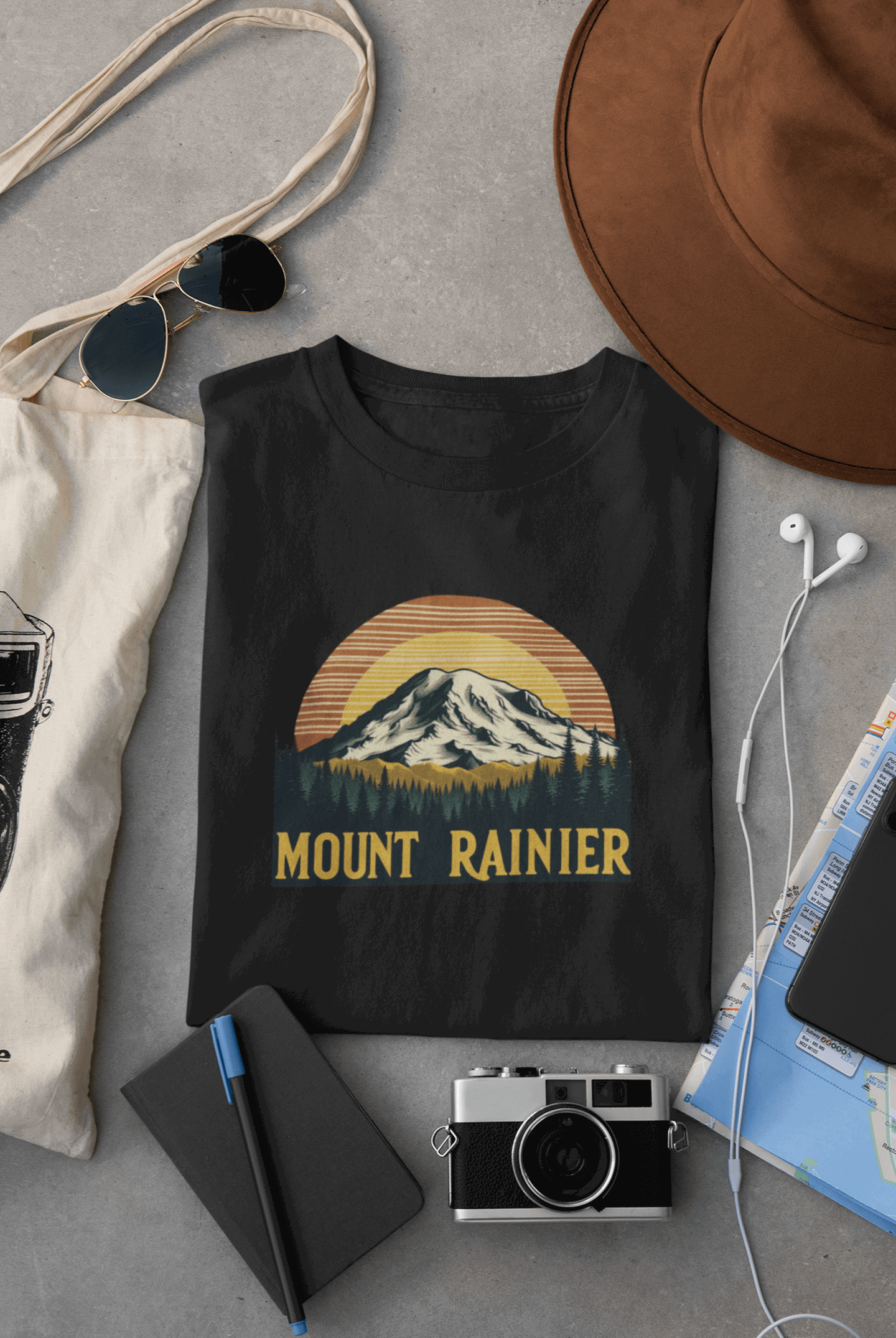 Wyld Peak Mount Rainier National Park organic cotton tee in black laid flat on desk.
