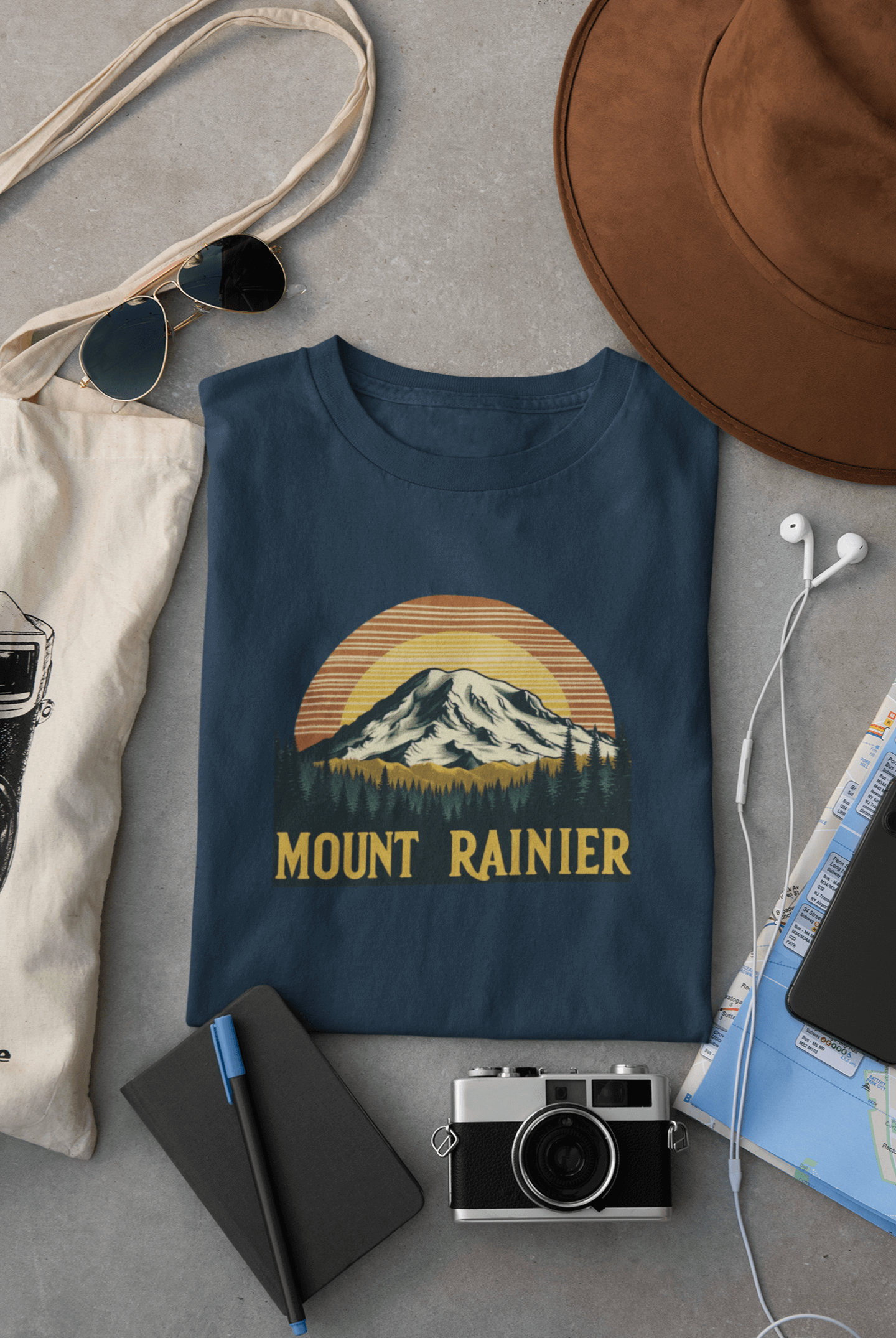 Navy Mount Rainier National Park tee from Wyld Peak flat lay on desk.