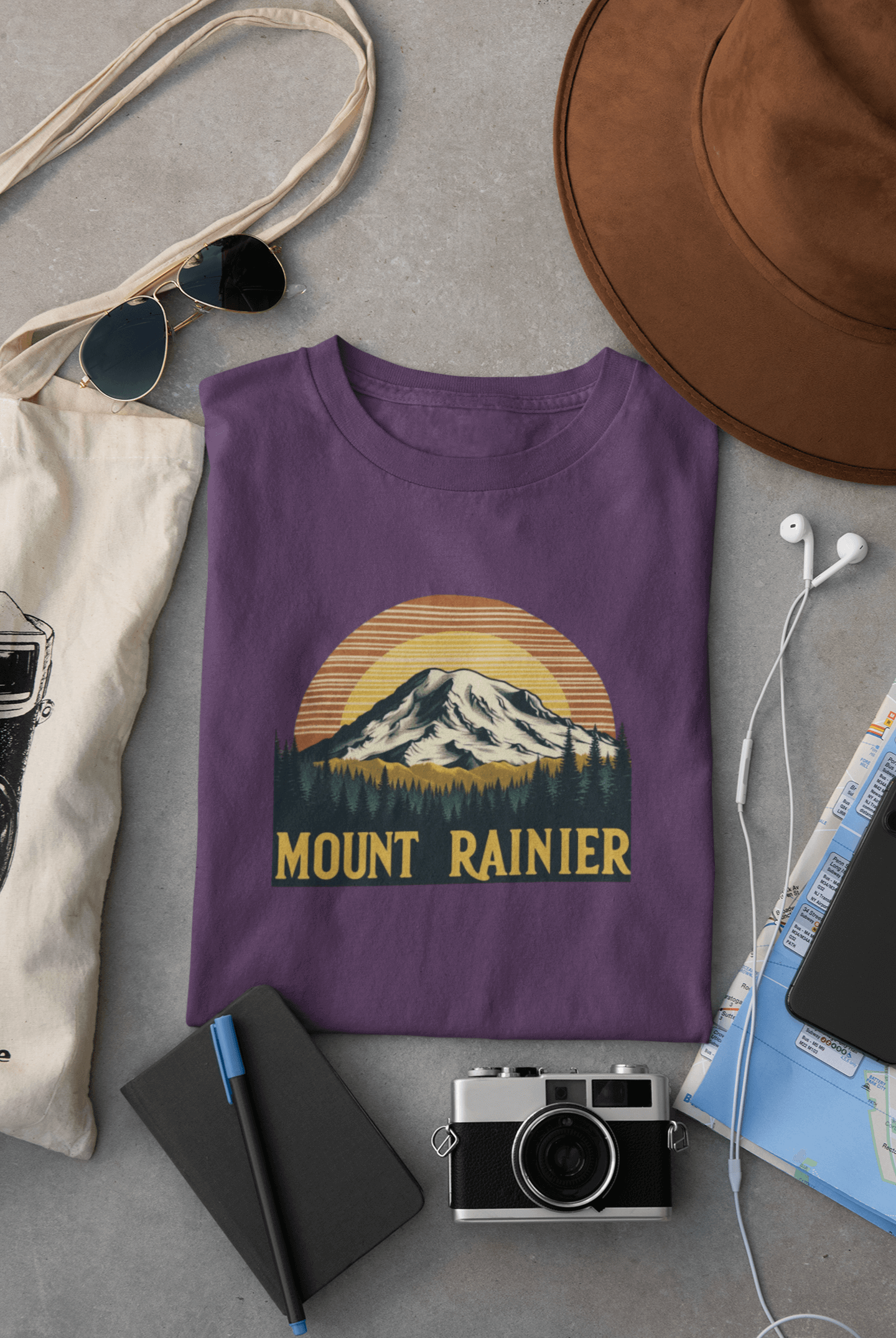 Purple Mount Rainier National Park tee from Wyld Peak flat lay on desk.