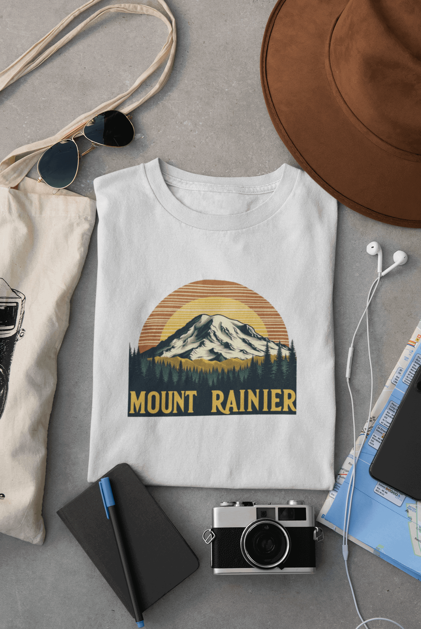 Wyld Peak Mount Rainier National Park organic cotton tee in white laid flat on desk.