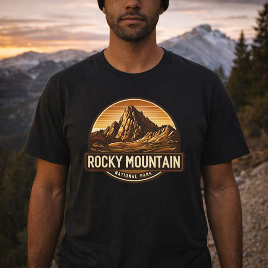 Person wearing a black t-shirt with Rocky Mountain National Park graphic in front of a mountainous landscape.