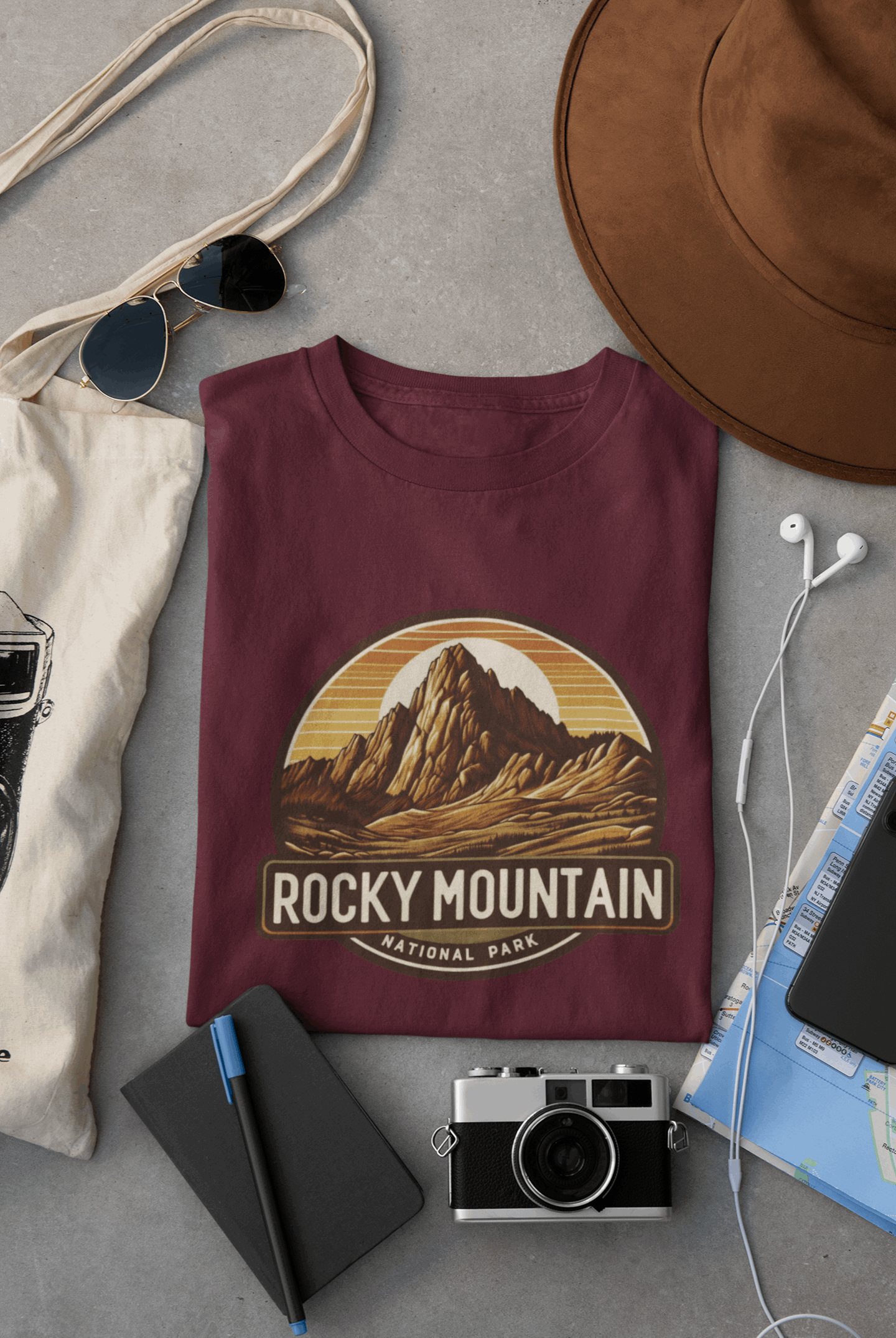 Maroon Wyld Peak Rocky Mountain National Park organic cotton tee laid flat on desk.