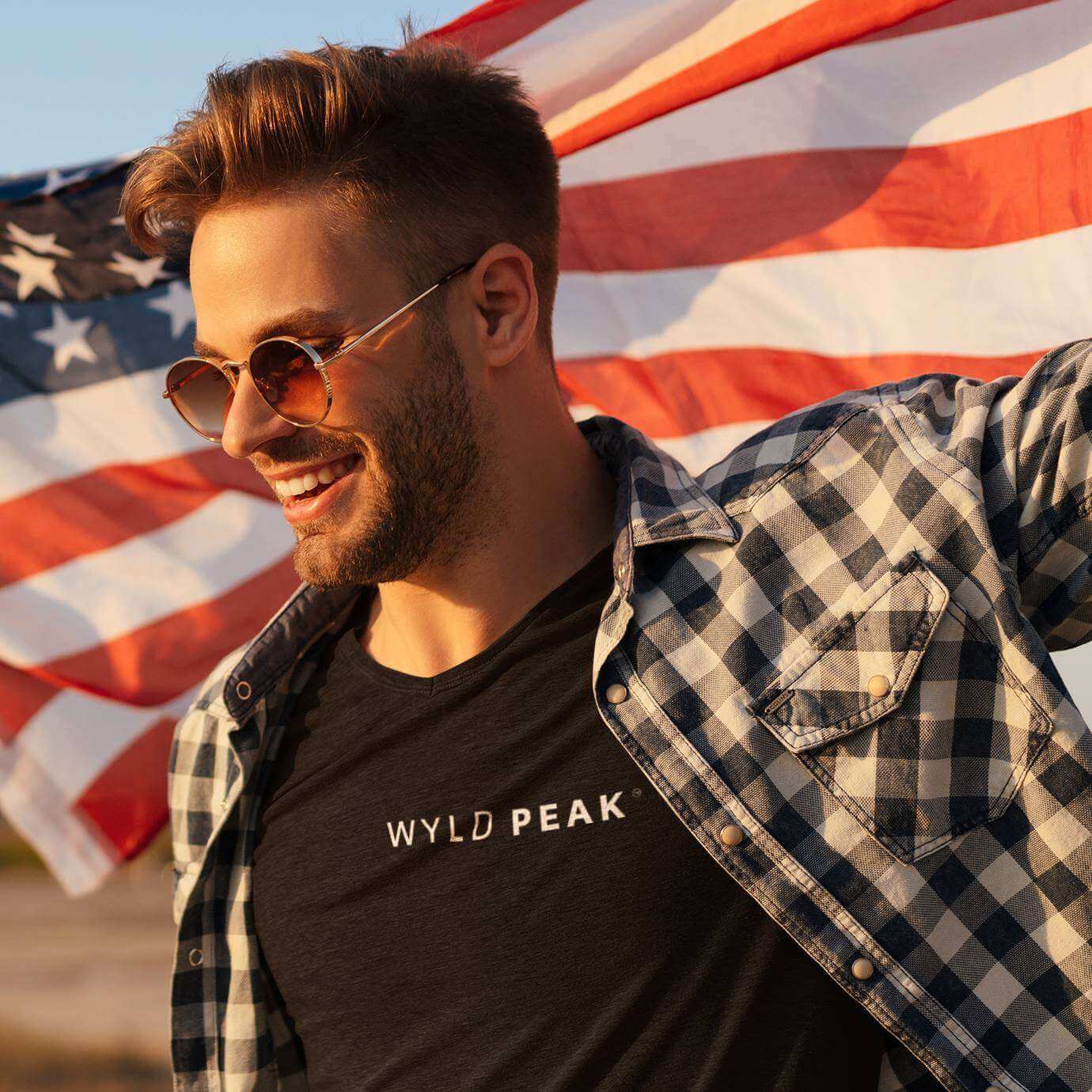 Man wearing Wyld Peak Signature tee in black with American flag design.