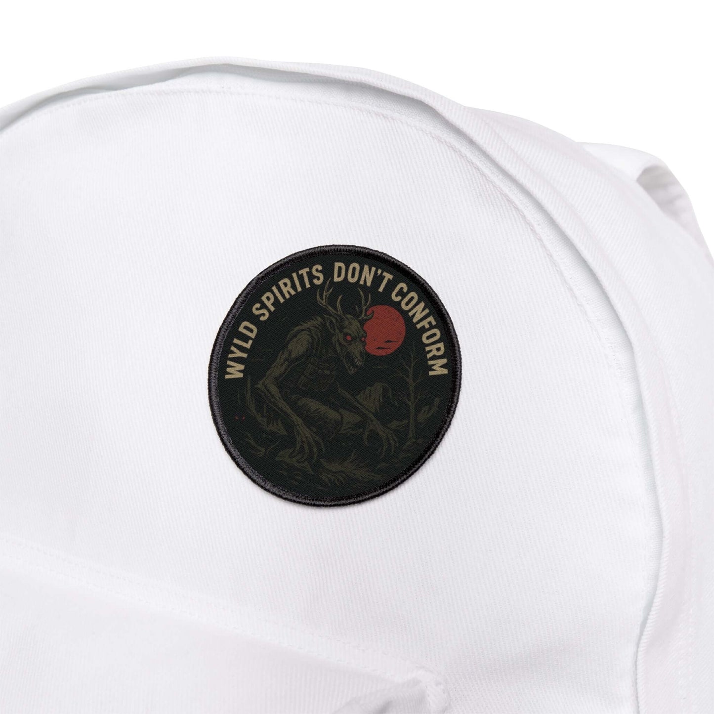 Wyld Peak Skinwalker cryptid patch on a white backpack during a hike