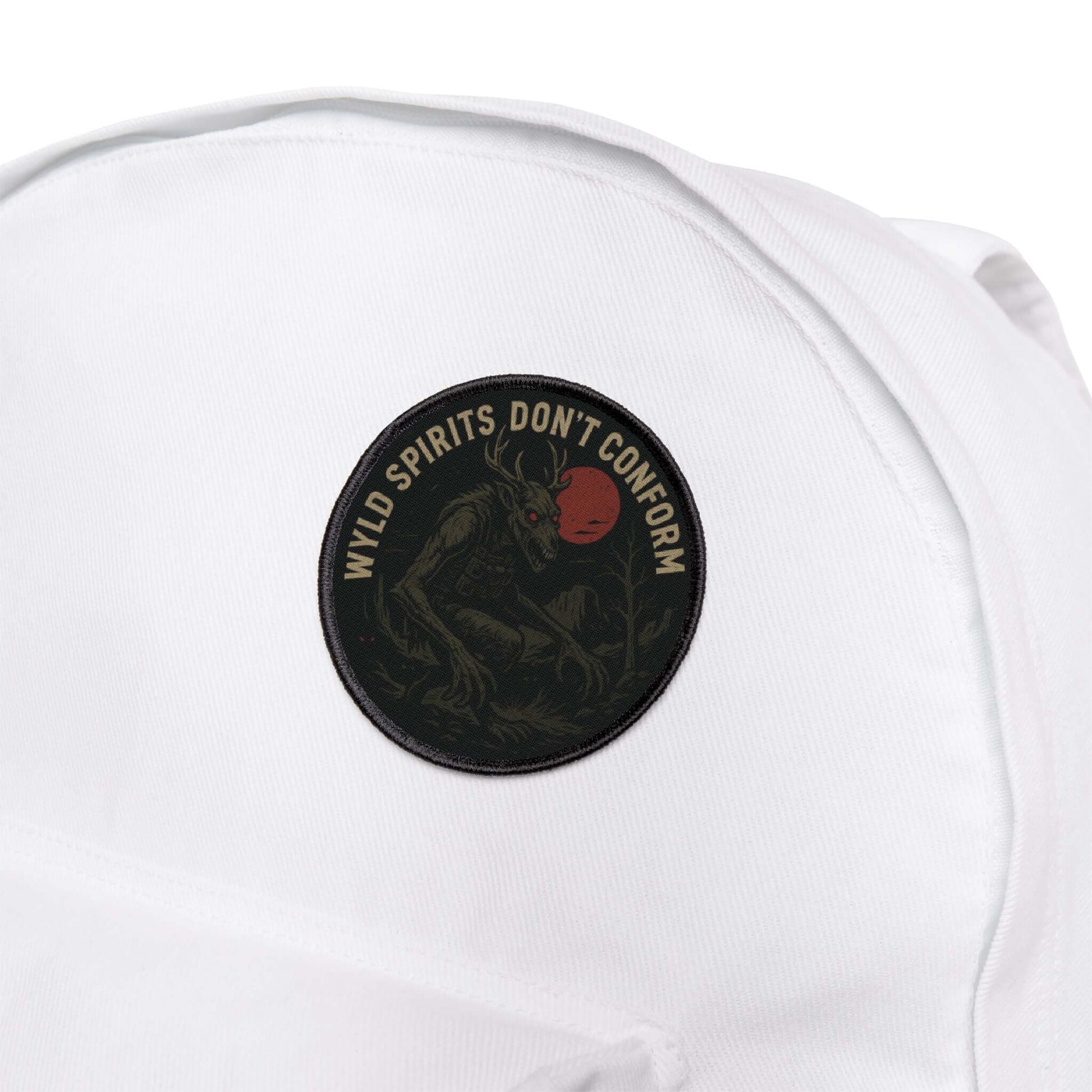 Wyld Peak Skinwalker cryptid patch on a white backpack during a hike