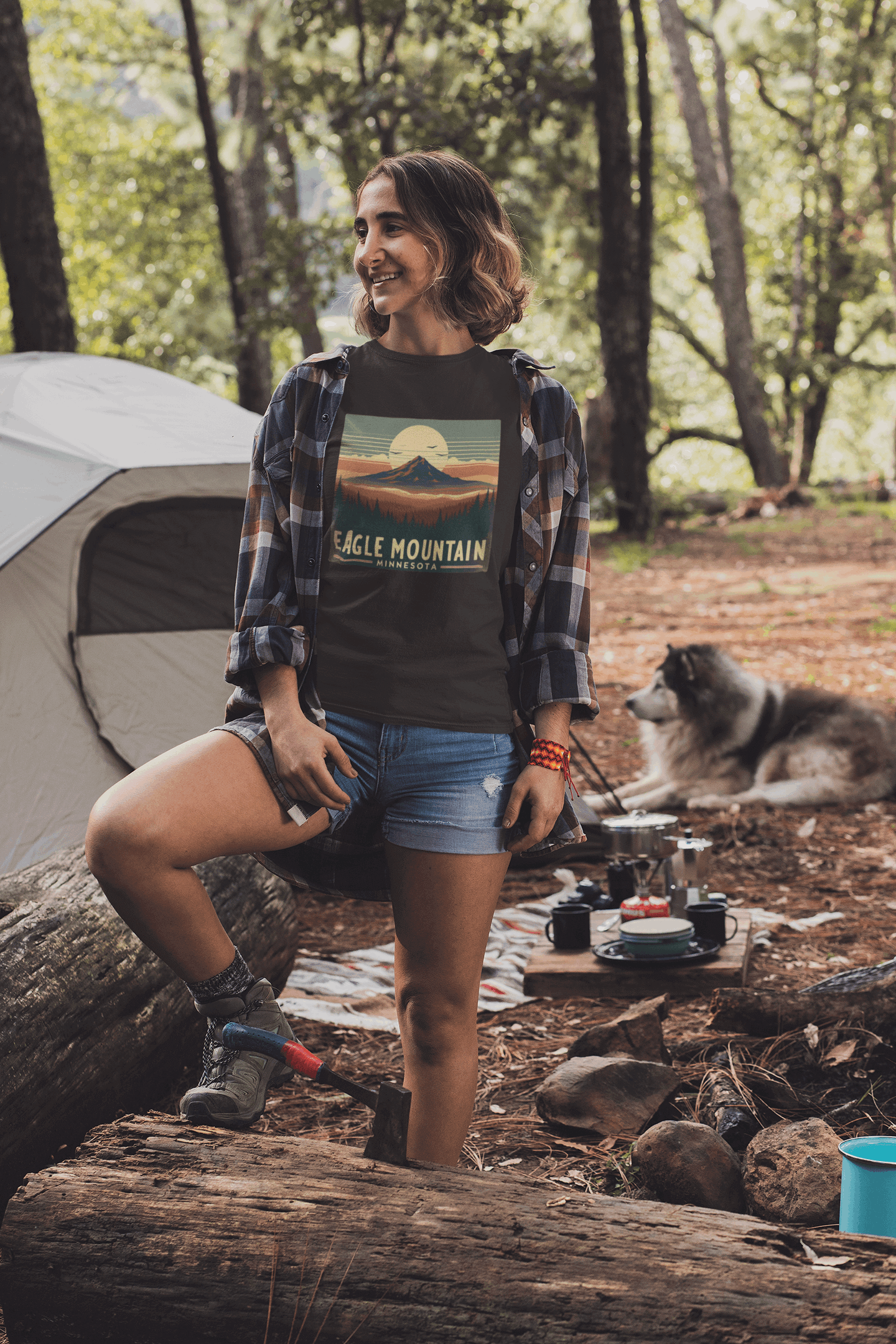 Woman wearing black Superior National Forest tee by Wyld Peak while camping