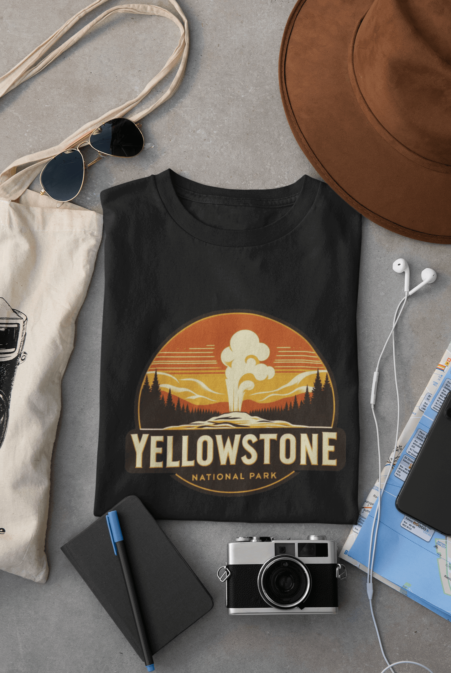 Black Yellowstone National Park tee from Wyld Peak flat lay on desk.