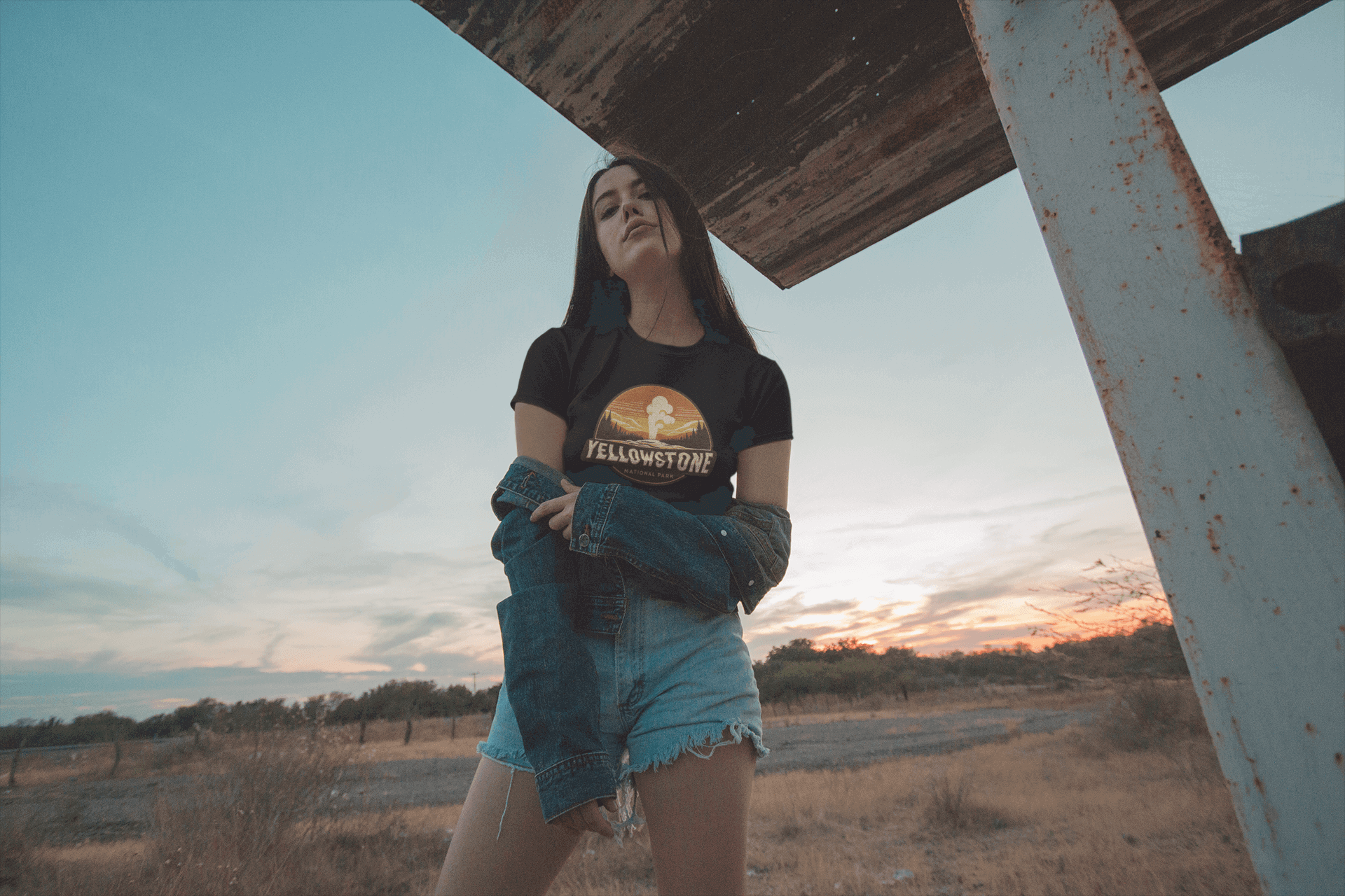 Black Yellowstone National Park tee from Wyld Peak worn by a woman at scenic sunset