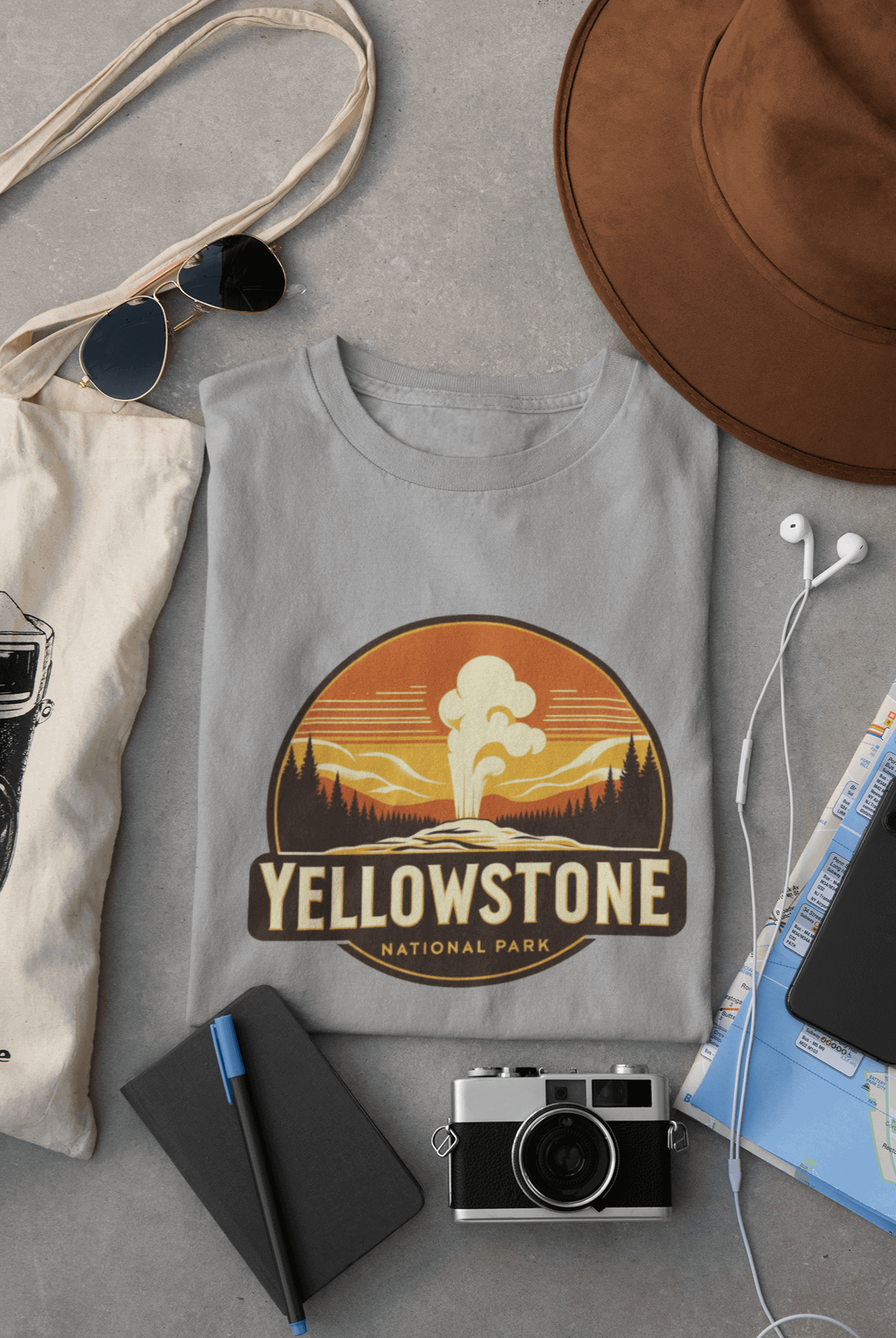 Grey Yellowstone National Park tee from Wyld Peak flat lay on desk.