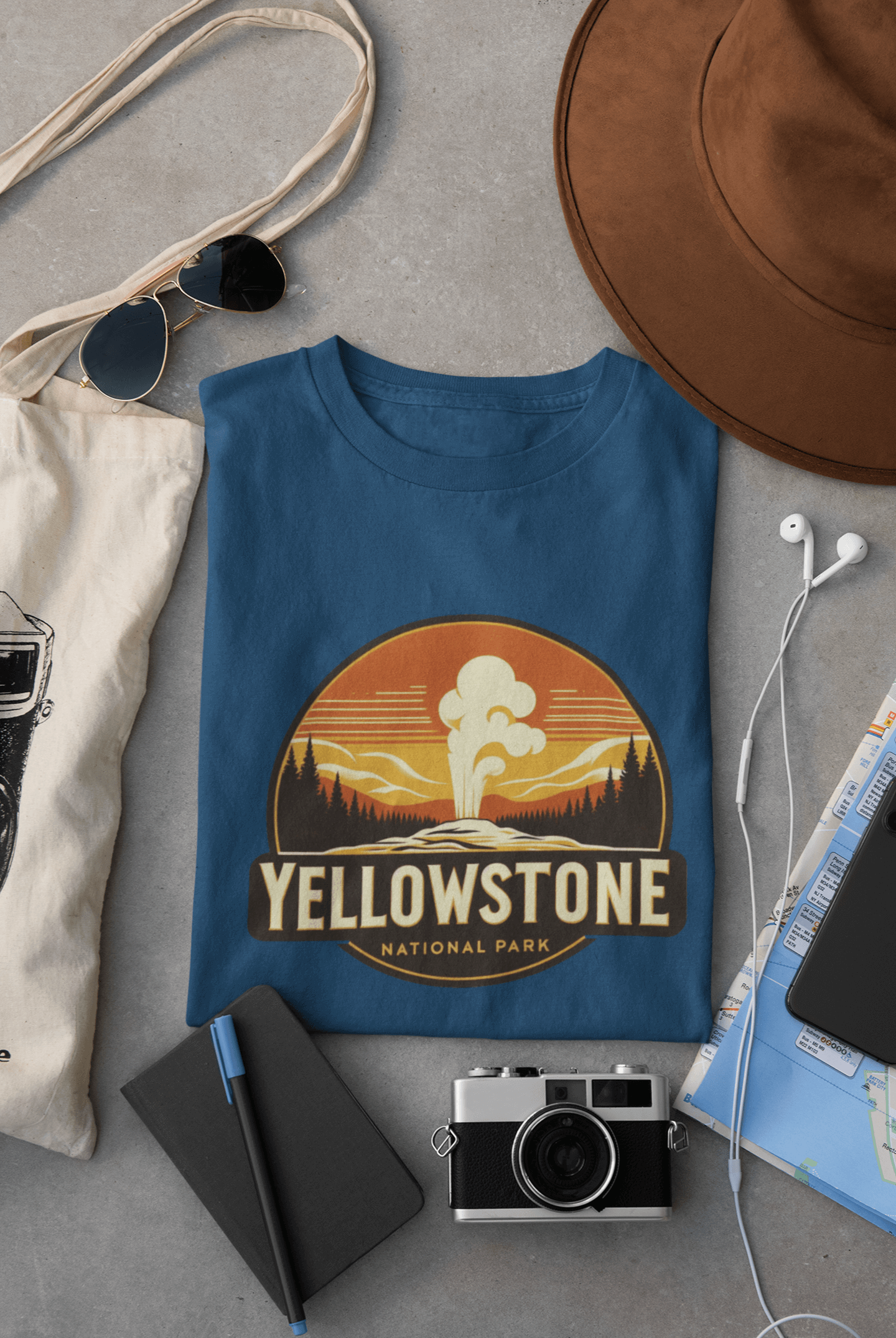 Indigo blue Yellowstone National Park tee from Wyld Peak flat lay on desk.