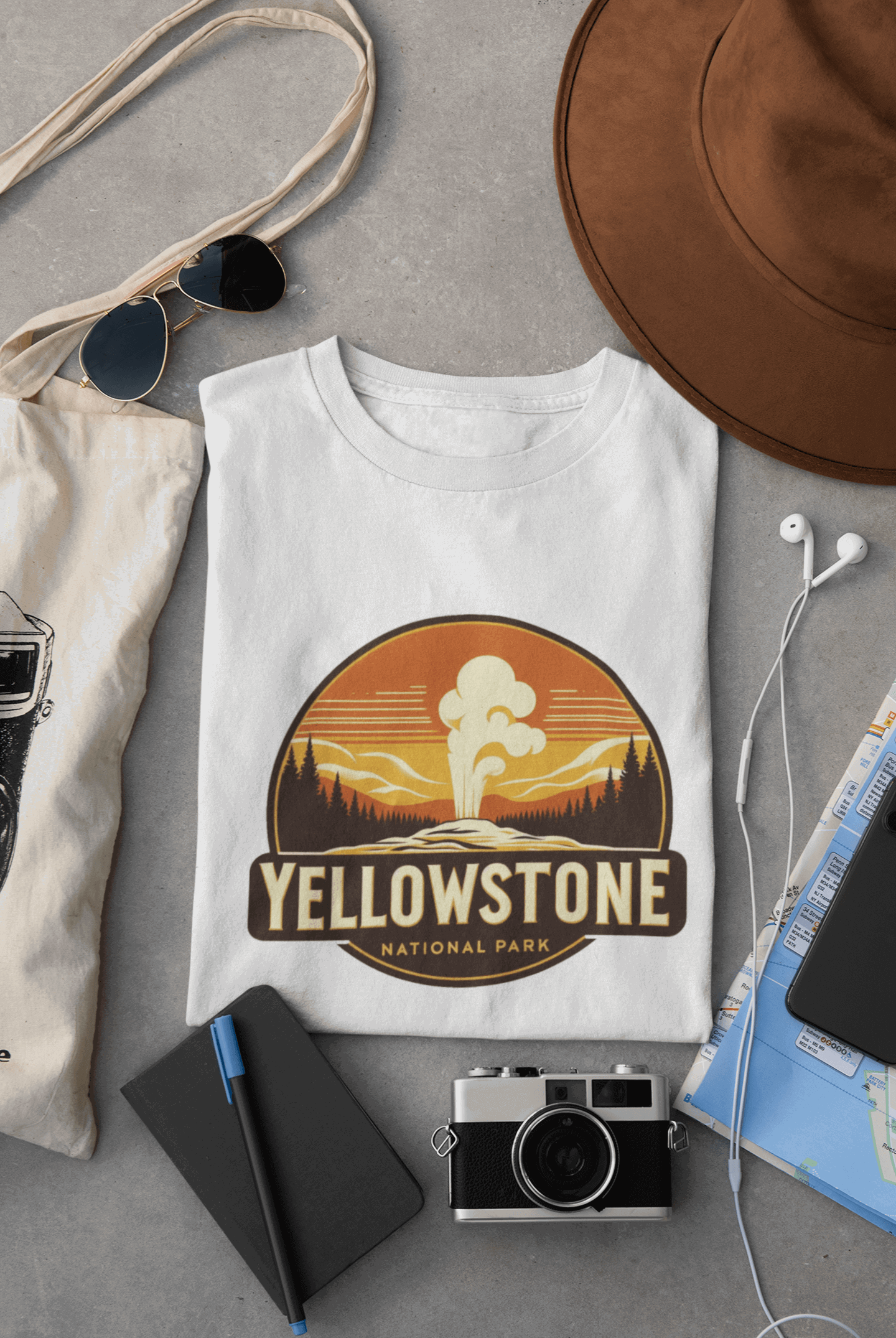 White Yellowstone National Park tee from Wyld Peak flat lay on desk.
